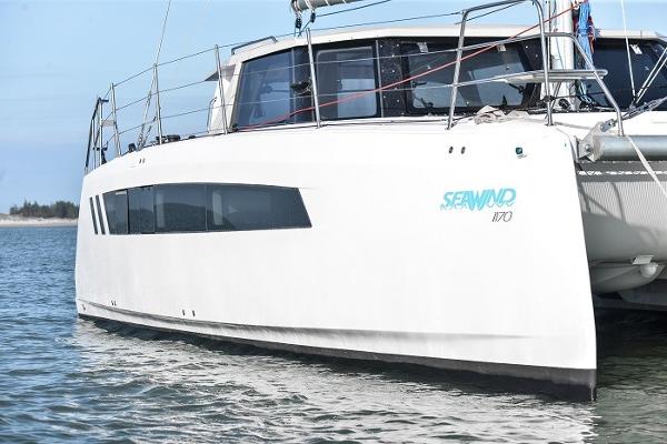 2025 Seawind 1170 catamaran on water, side view.