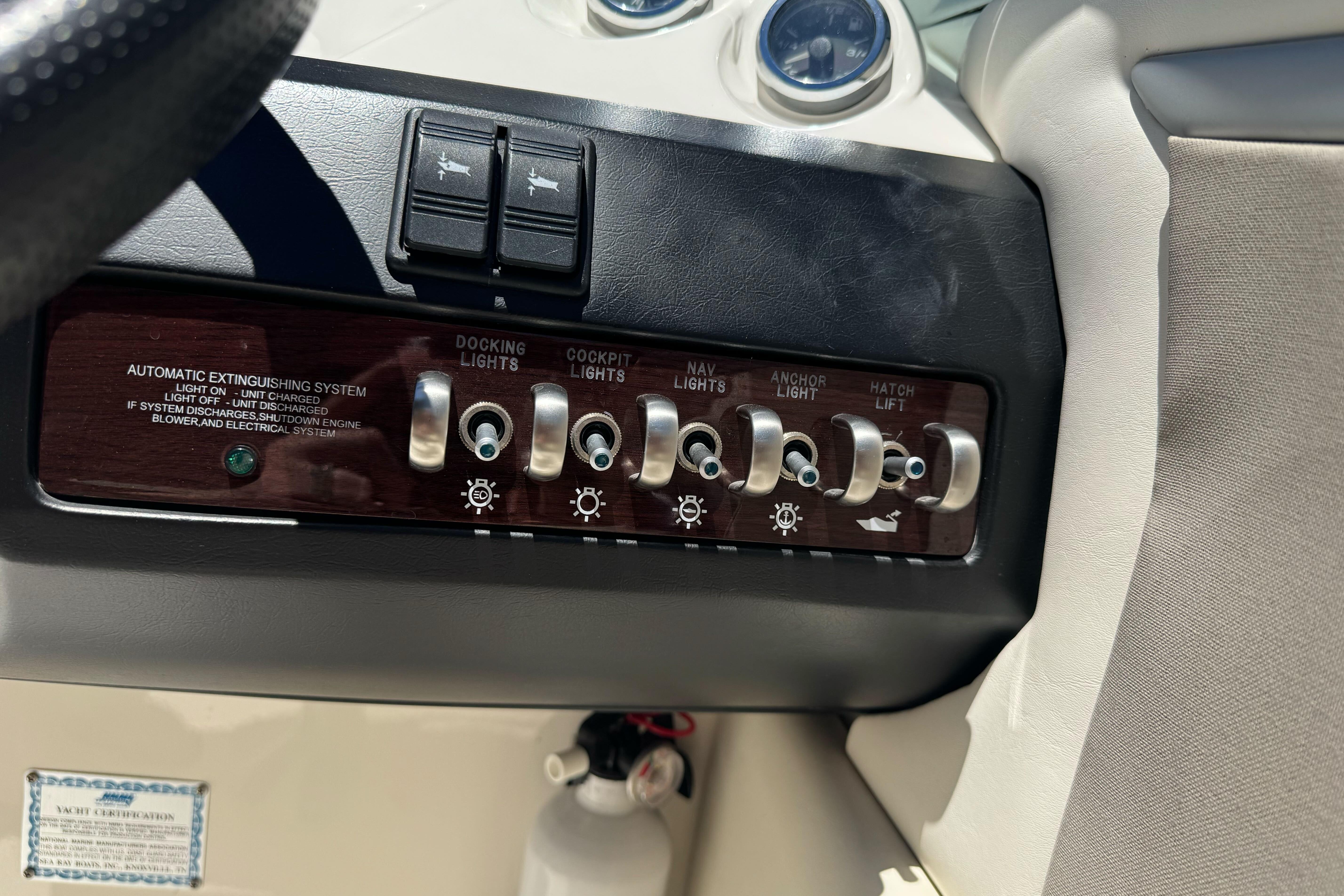 Control panel of a 2007 Sea Ray SLX 250 boat with various switches and gauges.