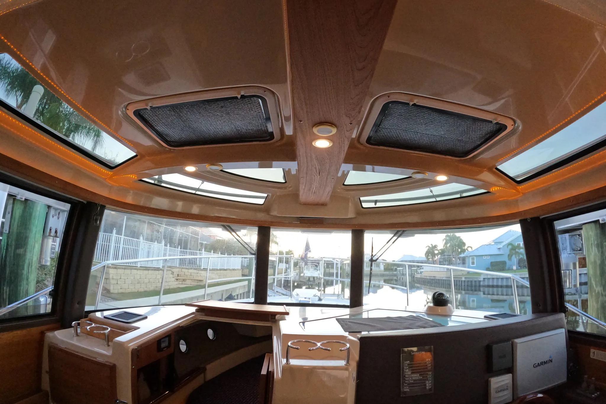 Interior view of 2015 Ranger Tugs R-29 S boat with panoramic windows and modern dashboard.