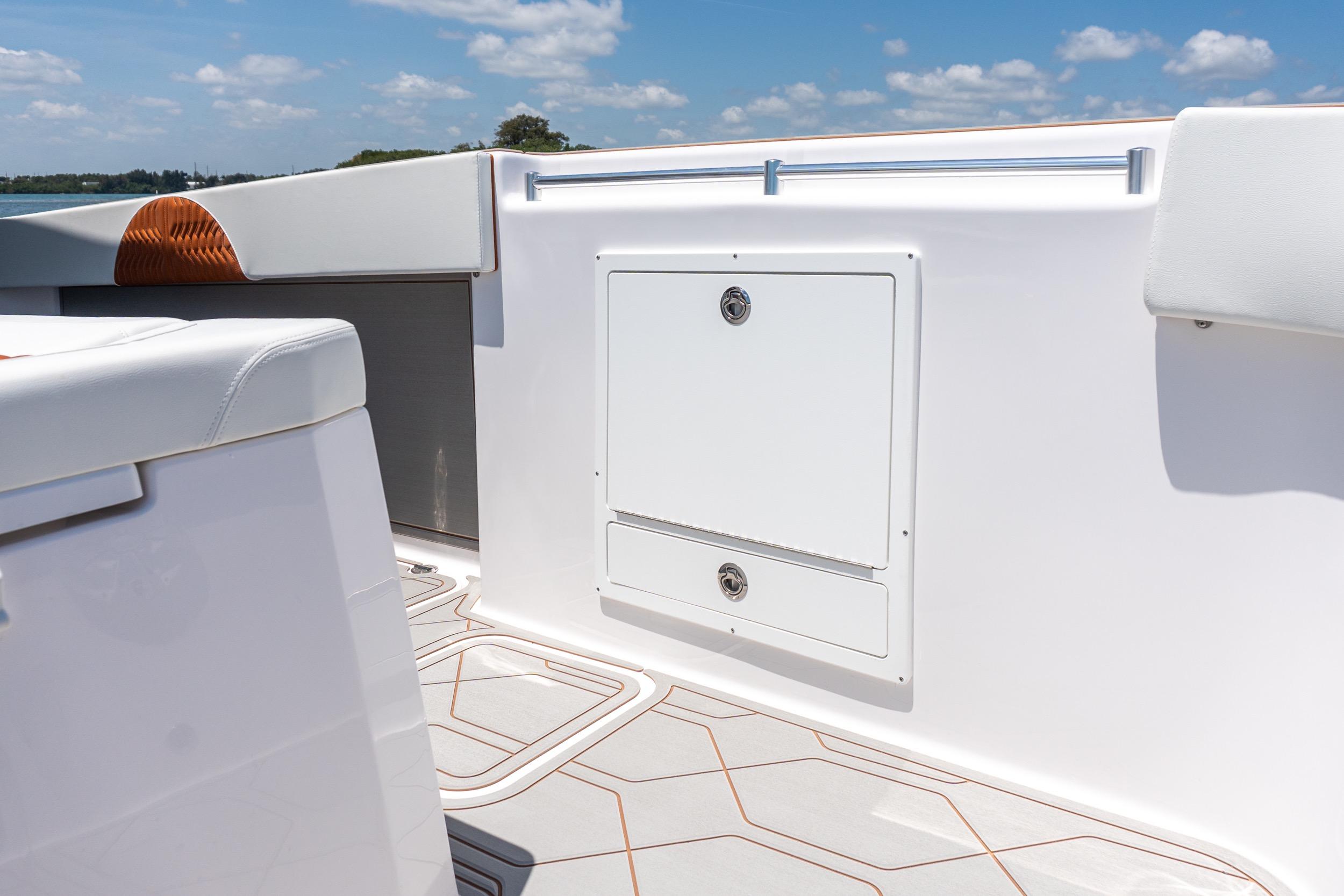 Interior view of 2026 Twin Vee 400 GFX2 CC boat, featuring sleek white seating and storage.