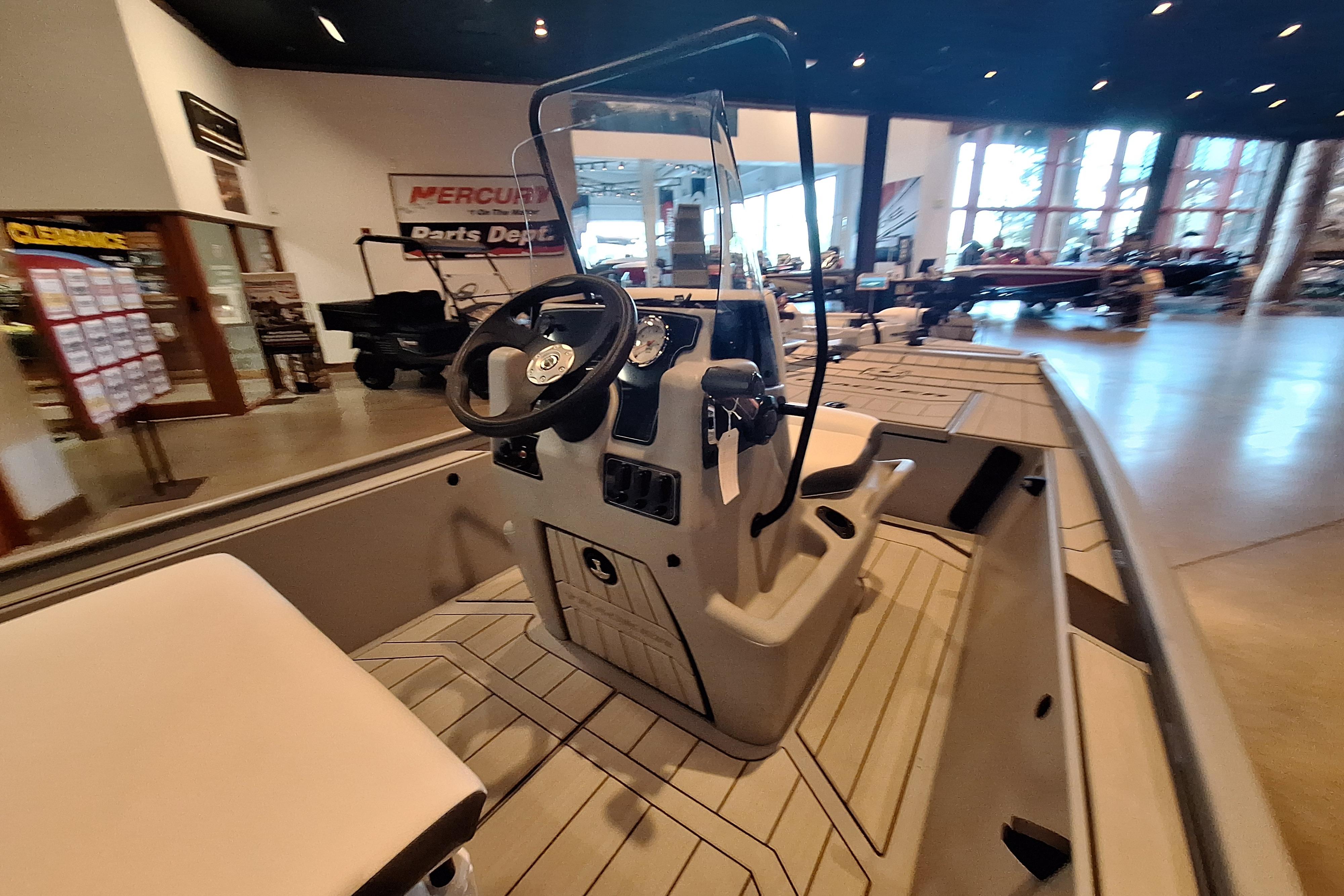 2026 Tracker Bass Tracker Classic CC boat interior with steering console in showroom.