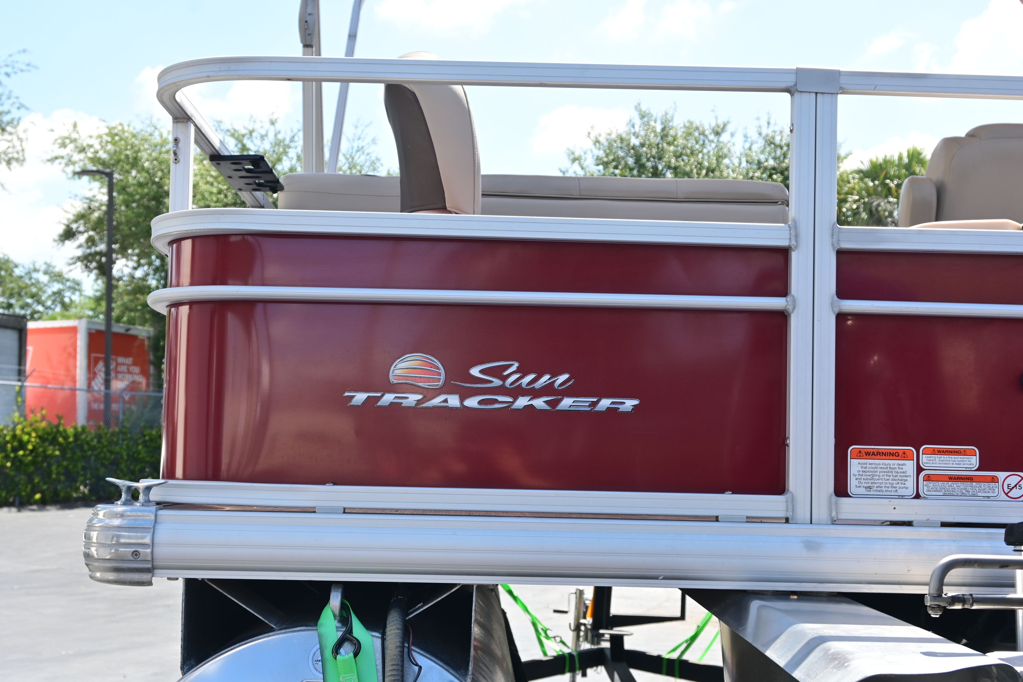 2019 Sun Tracker FISHI pontoon boat, red side view.