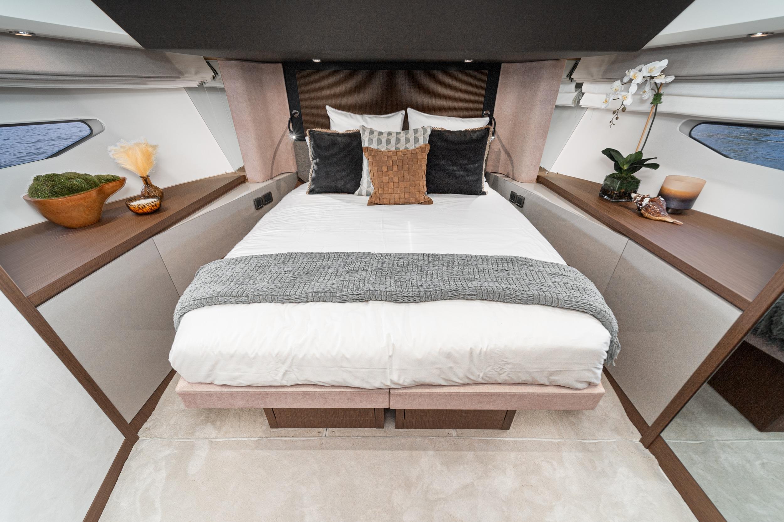 Luxurious bedroom interior of 2024 Prestige X60 yacht with elegant decor and cozy bedding.