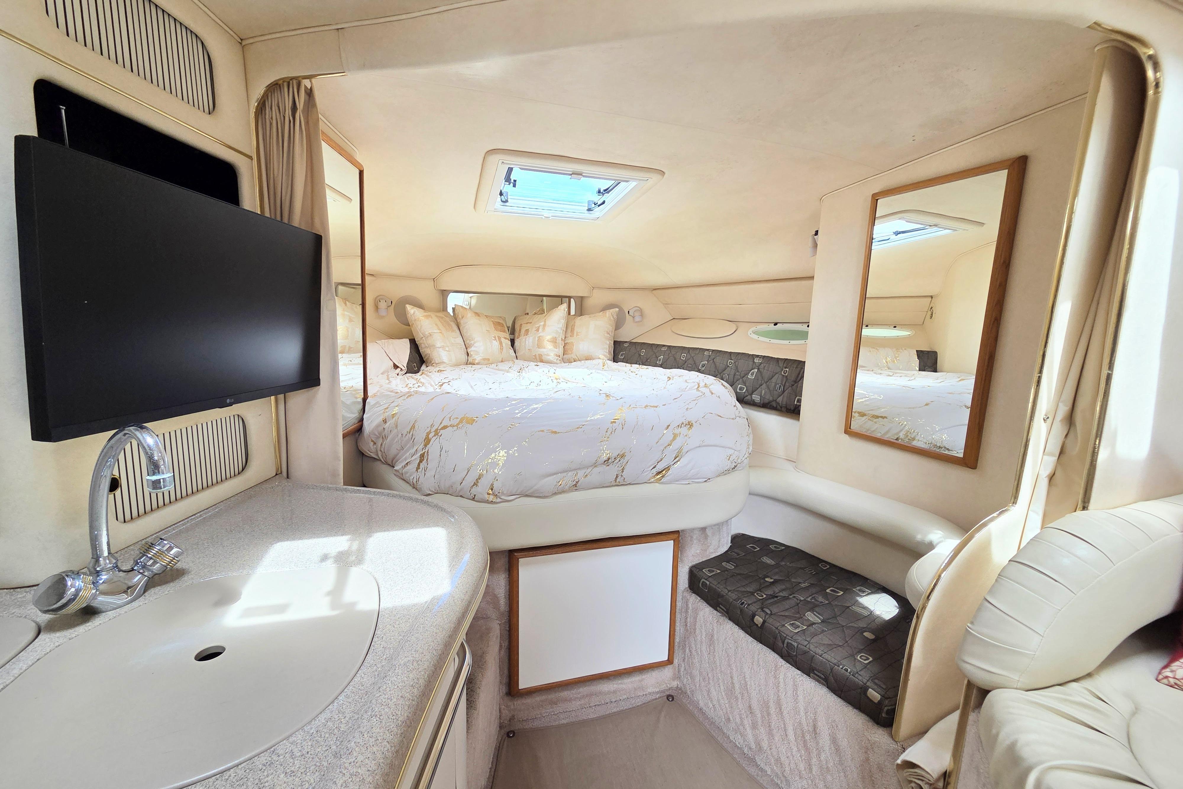 Luxurious interior of 2000 Sea Ray 340 Sundancer with cozy bed and modern amenities.