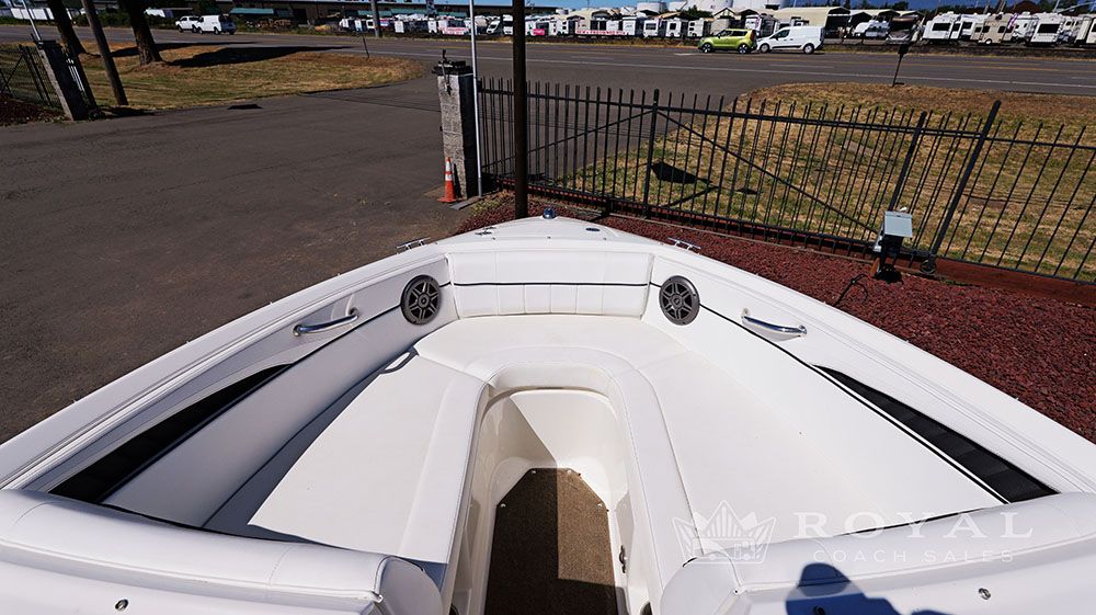 Bow area of a Sea Ray SLX 230 boat with white upholstery and speakers.