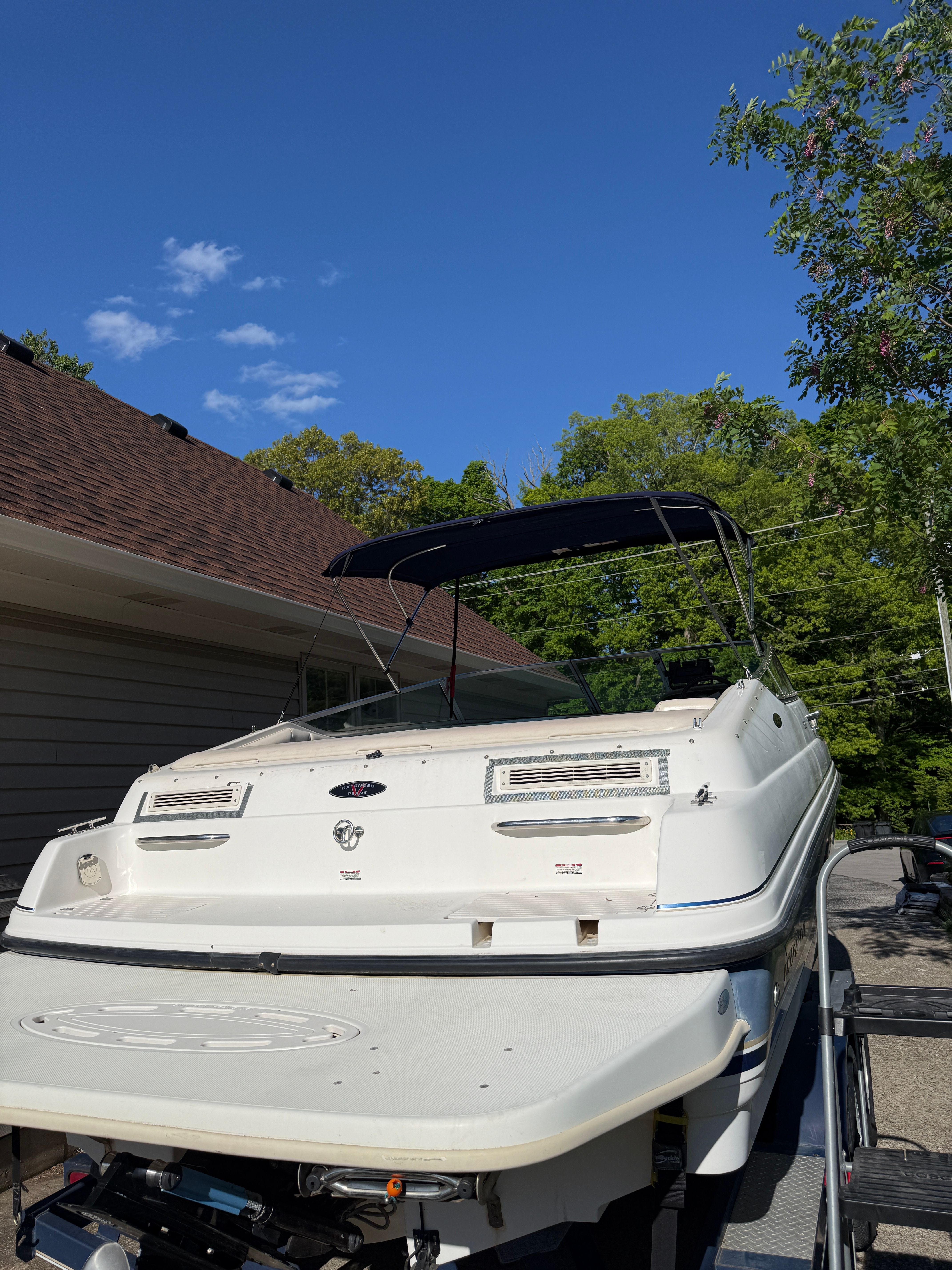1999 Custom 2335 Cuddy Cabin boat parked outdoors.