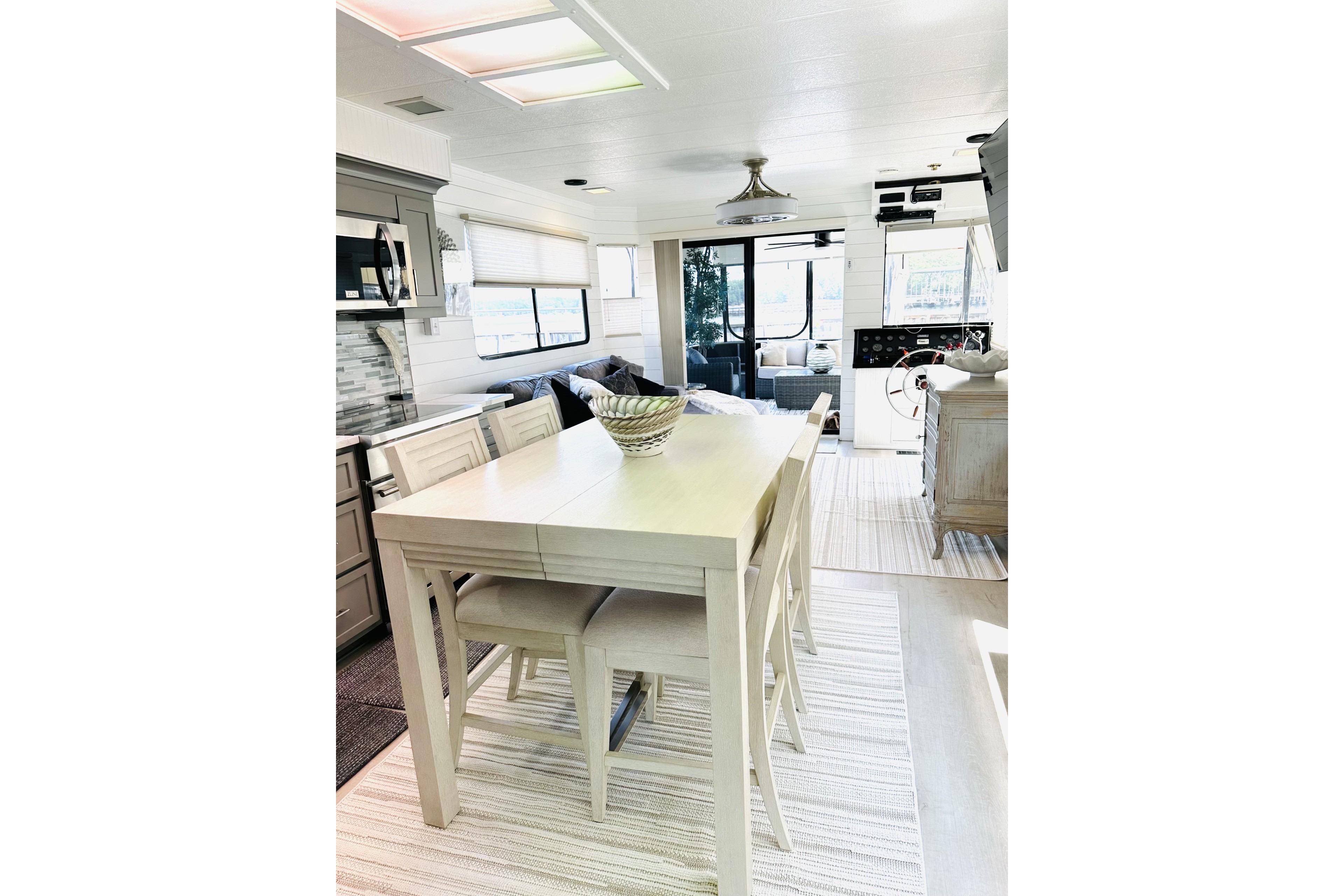 Interior of 1992 Sumerset 66 houseboat with modern dining area and stylish decor.