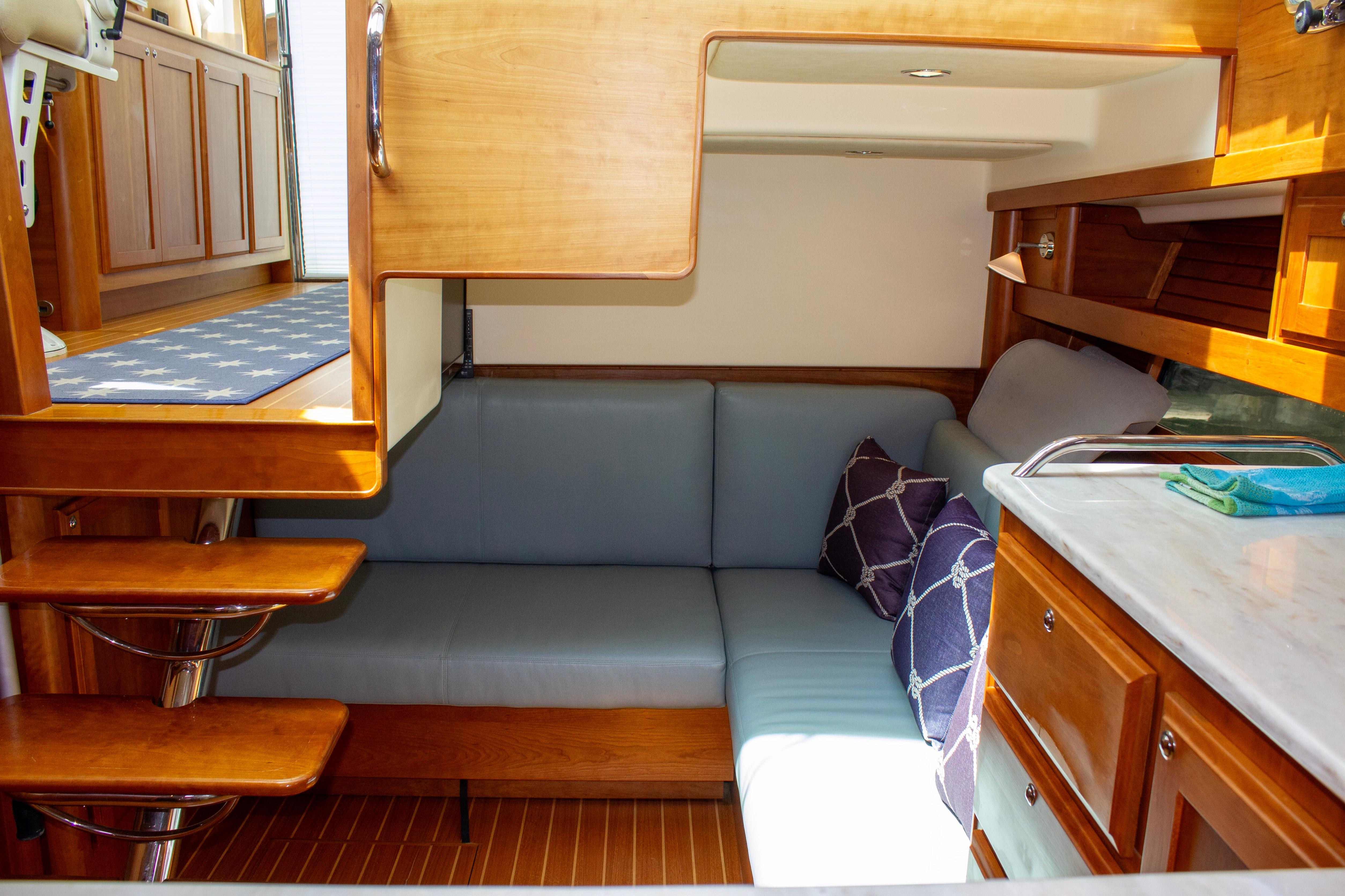 Interior of 2013 Sabre 38 Salon Express with cozy seating and wooden cabinetry.