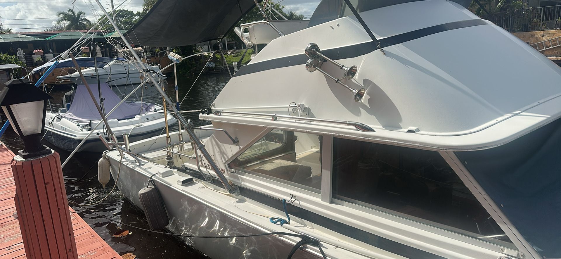 1974 Bertram 28 boat docked in sunny weather.