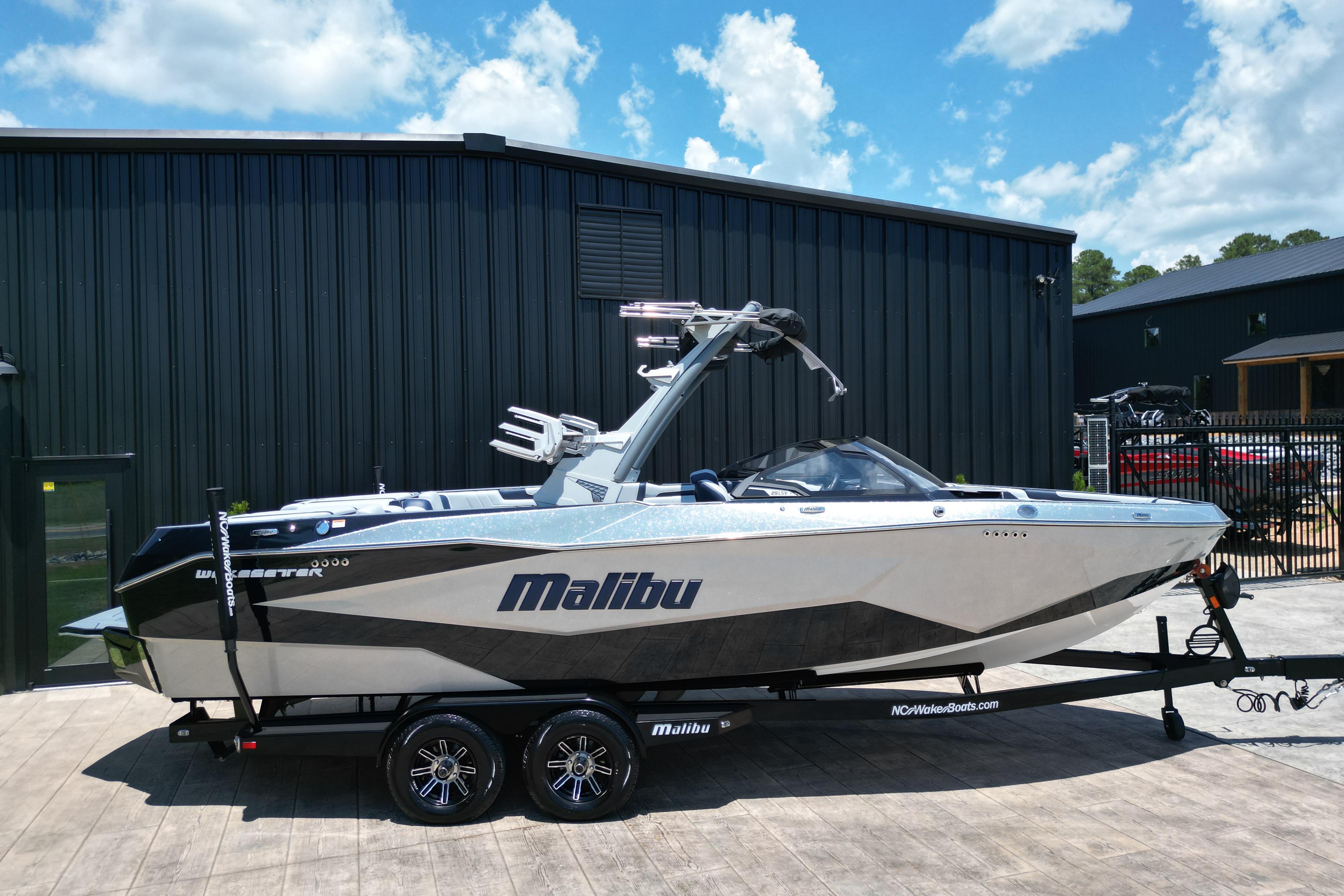 2025 Malibu Wakesetter 25 LSV boat on trailer, parked outdoors.