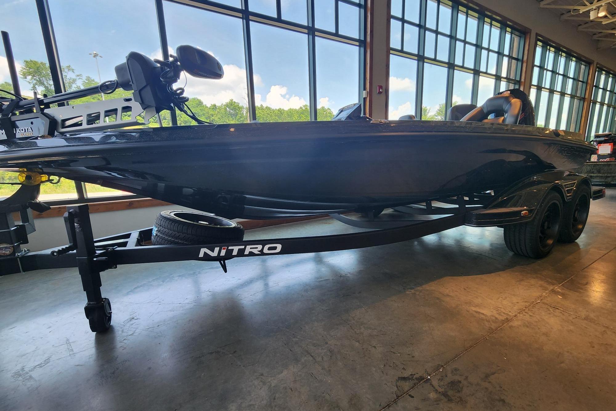2026 Nitro Z19 XL Pro boat displayed indoors with trailer, large windows in background.