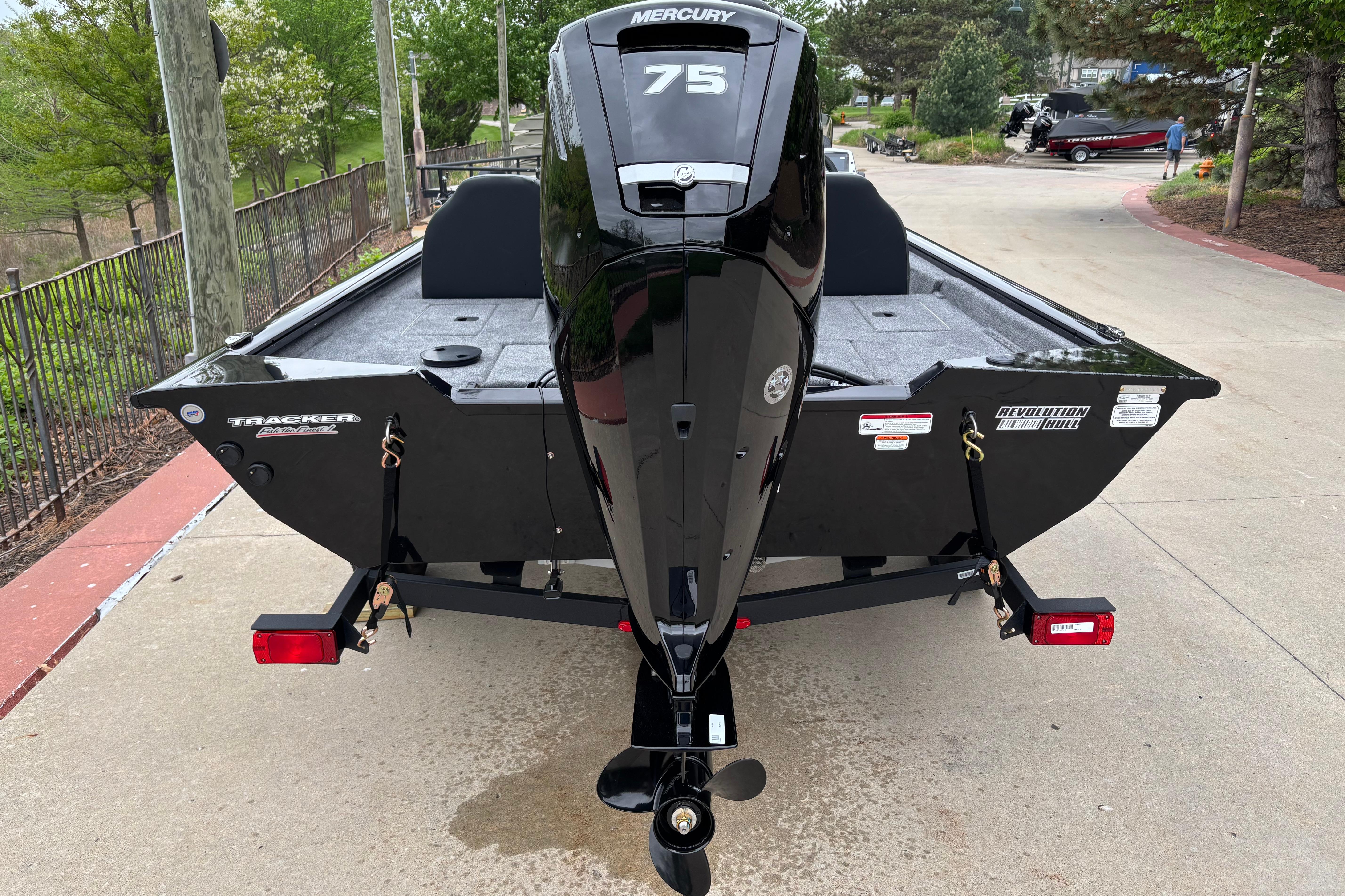 2026 Tracker Pro Team 175 boat with Mercury 75 engine, parked on a driveway.