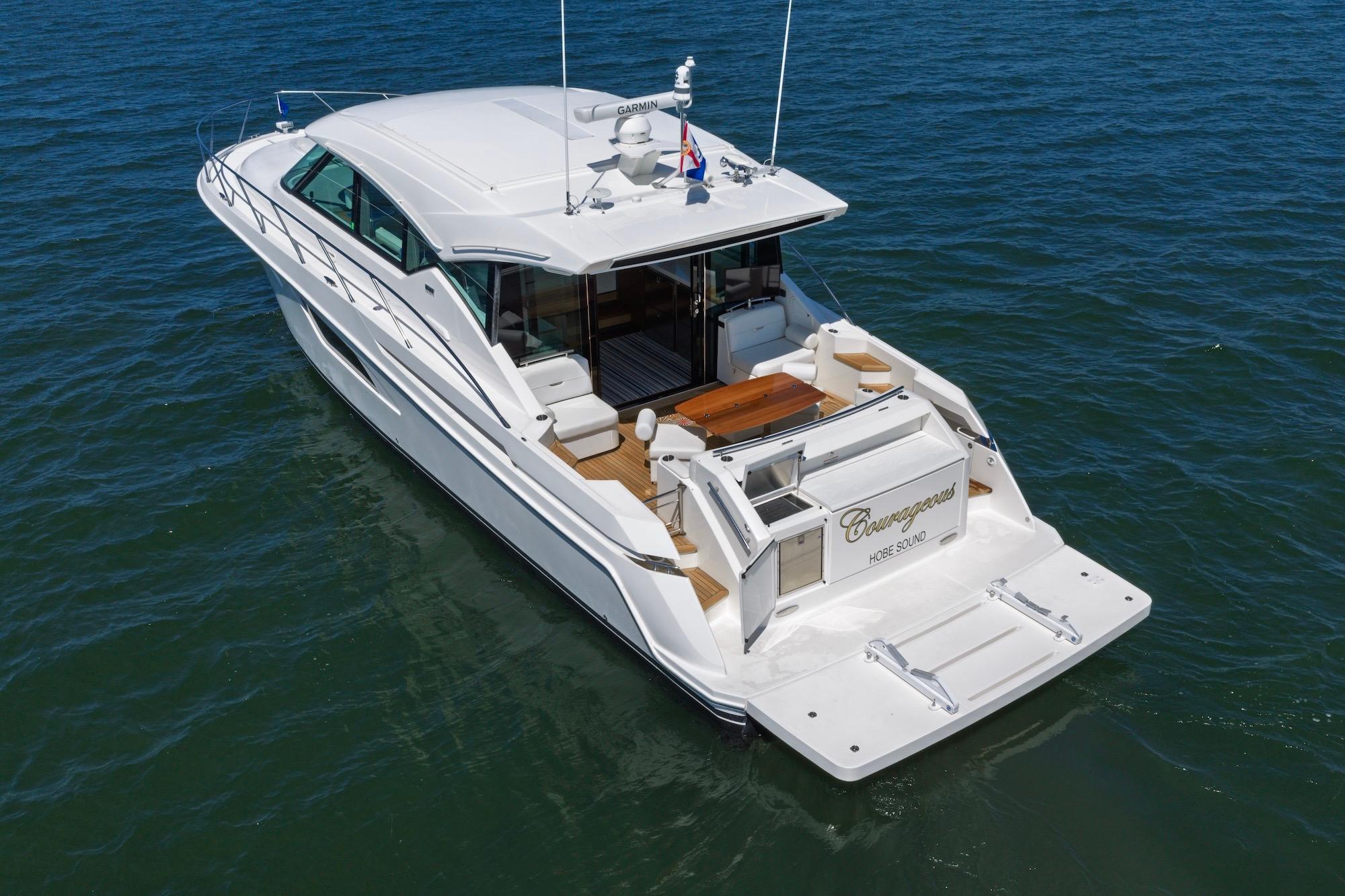 2020 Tiara Yachts C53 Coupe cruising on open water, rear view.