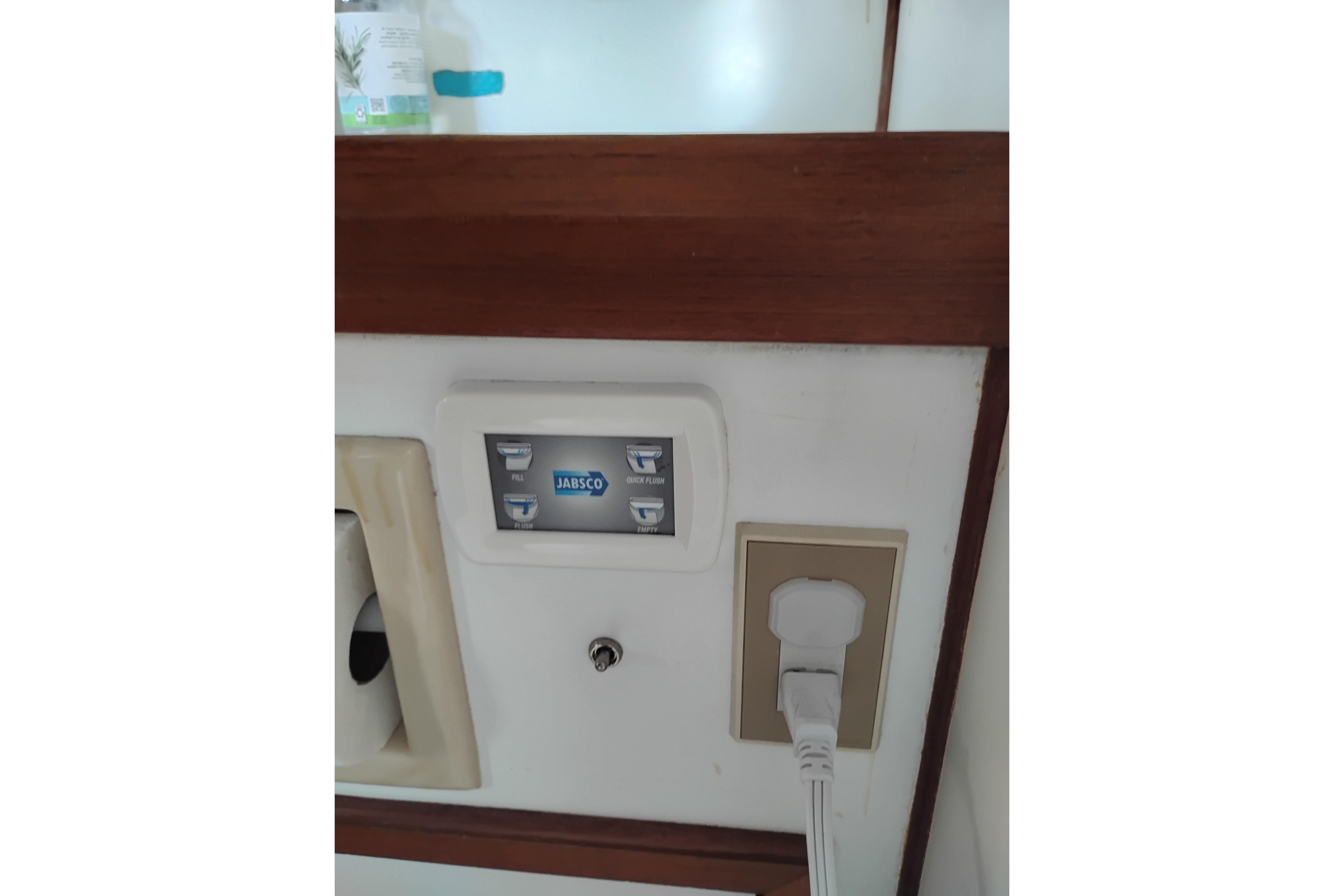 Control panel and outlet on 1988 Monk 36 Aft Cabin boat interior.