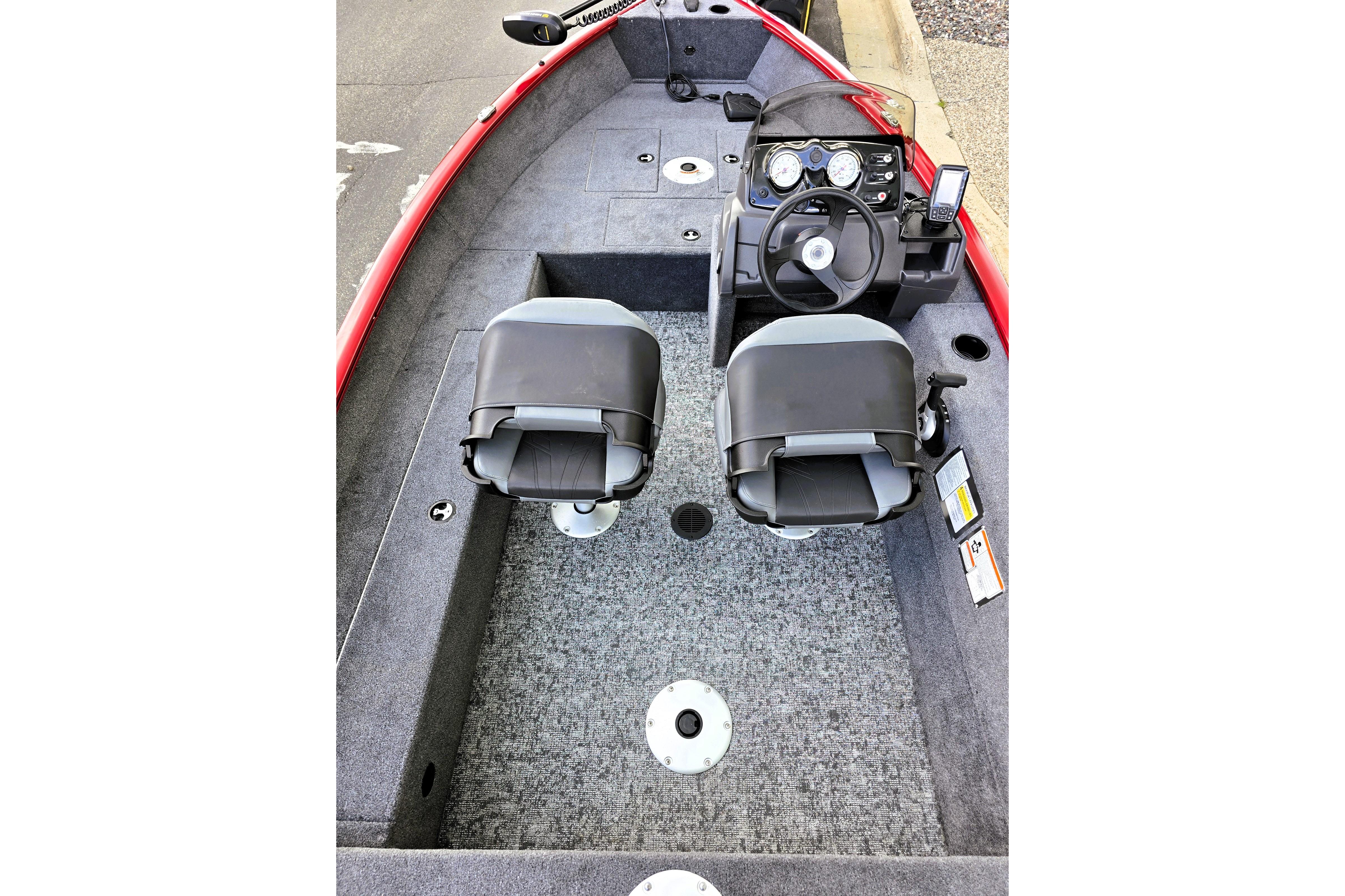 Interior of 2026 Tracker Super Guide V-16 SC boat with dual seats and steering console.