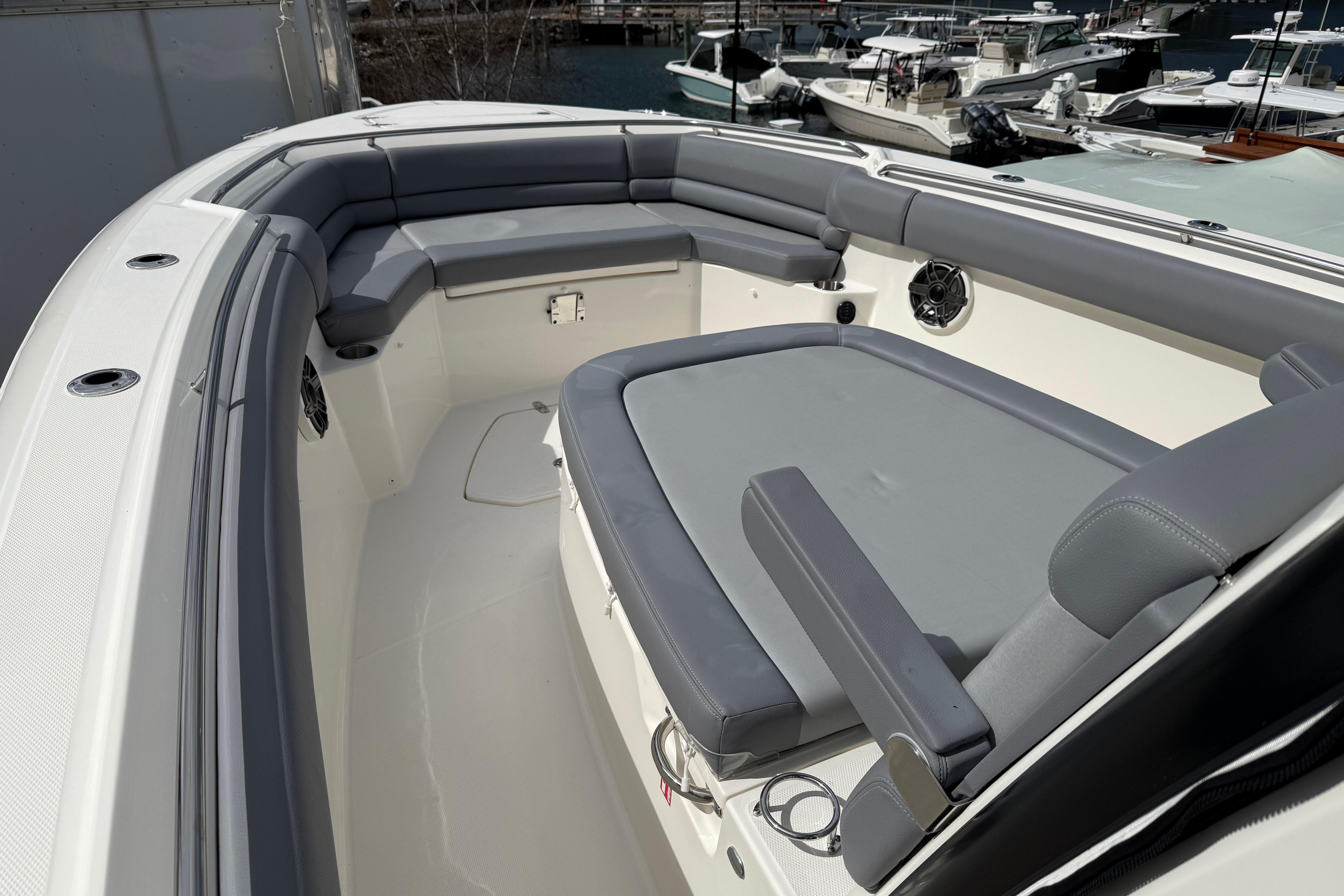 2026 Boston Whaler 330 Outrage boat interior with gray seating and spacious layout.