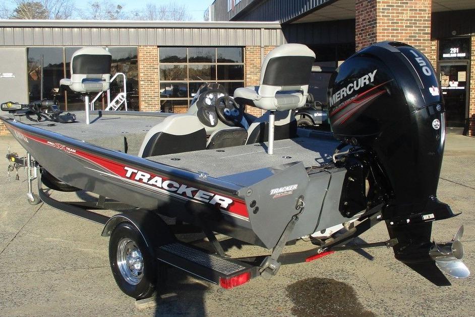 2017 Tracker Pro Team 195 TXW boat with Mercury engine, parked outside a building.