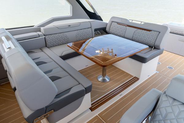 Manufacturer Provided Image: Luxurious seating area on 2026 Regal LX43 yacht with elegant wood table.