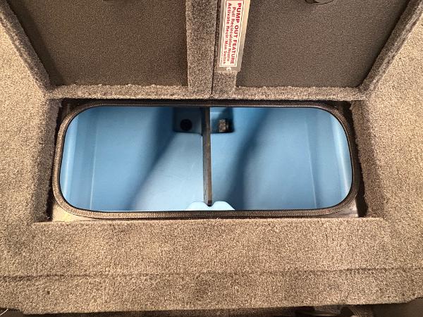 Open storage compartment in 2025 Tracker Savage 215 boat, featuring blue interior.