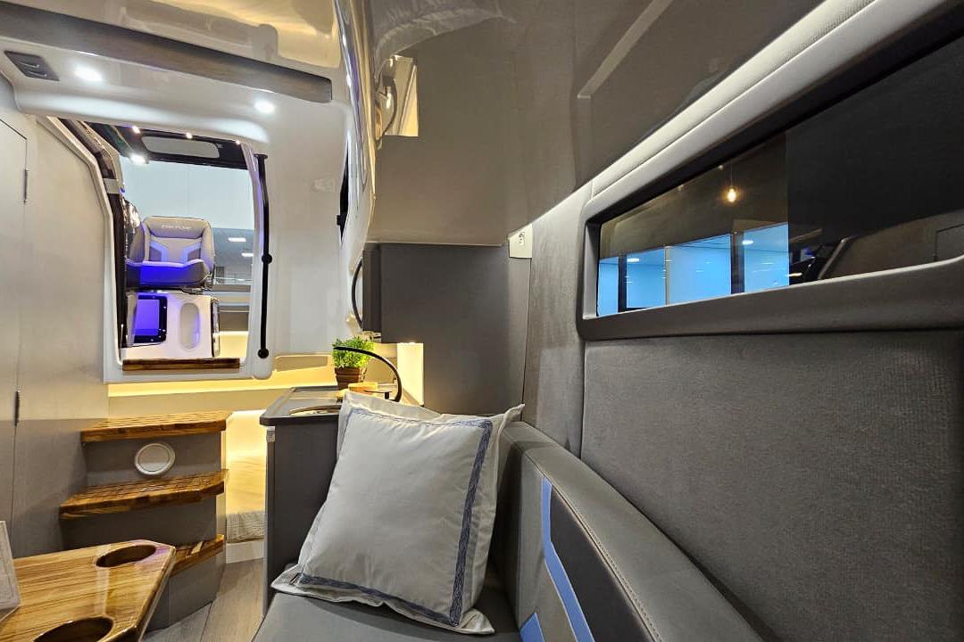 Interior of 2026 Hanover 327 RV, featuring modern seating and ambient lighting.
