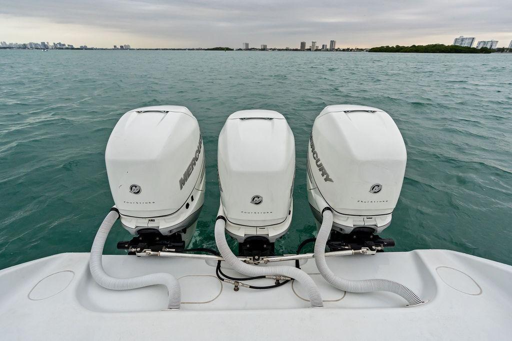 Triple Mercury outboard engines on 2021 Yellowfin 36 Offshore boat in open water.