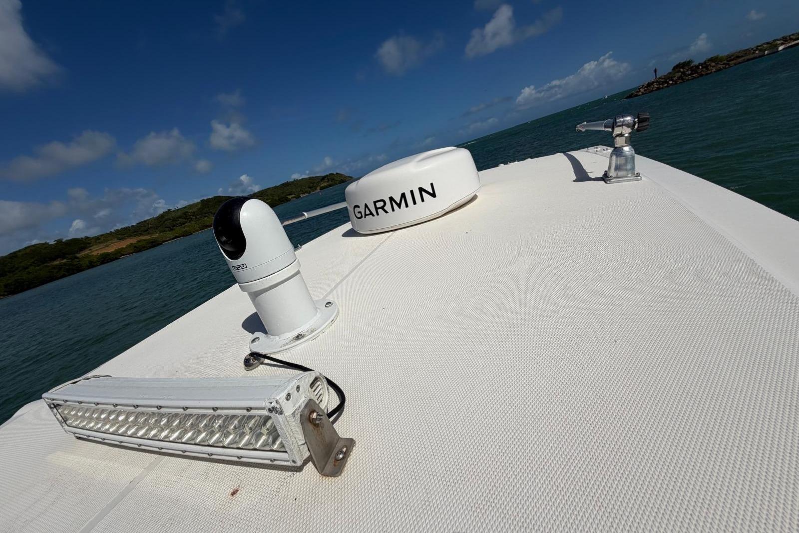 2023 Fountain 34 Center Console boat with Garmin equipment on deck, ocean view.