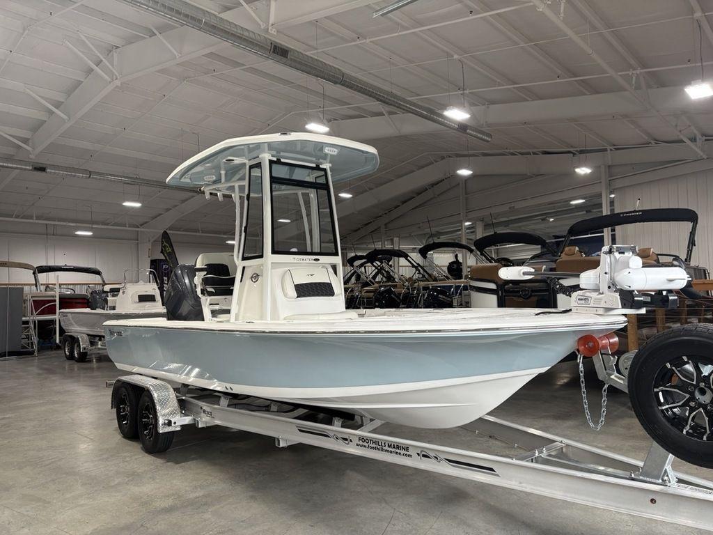 2026 Tidewater 2110 BM boat on trailer in showroom.