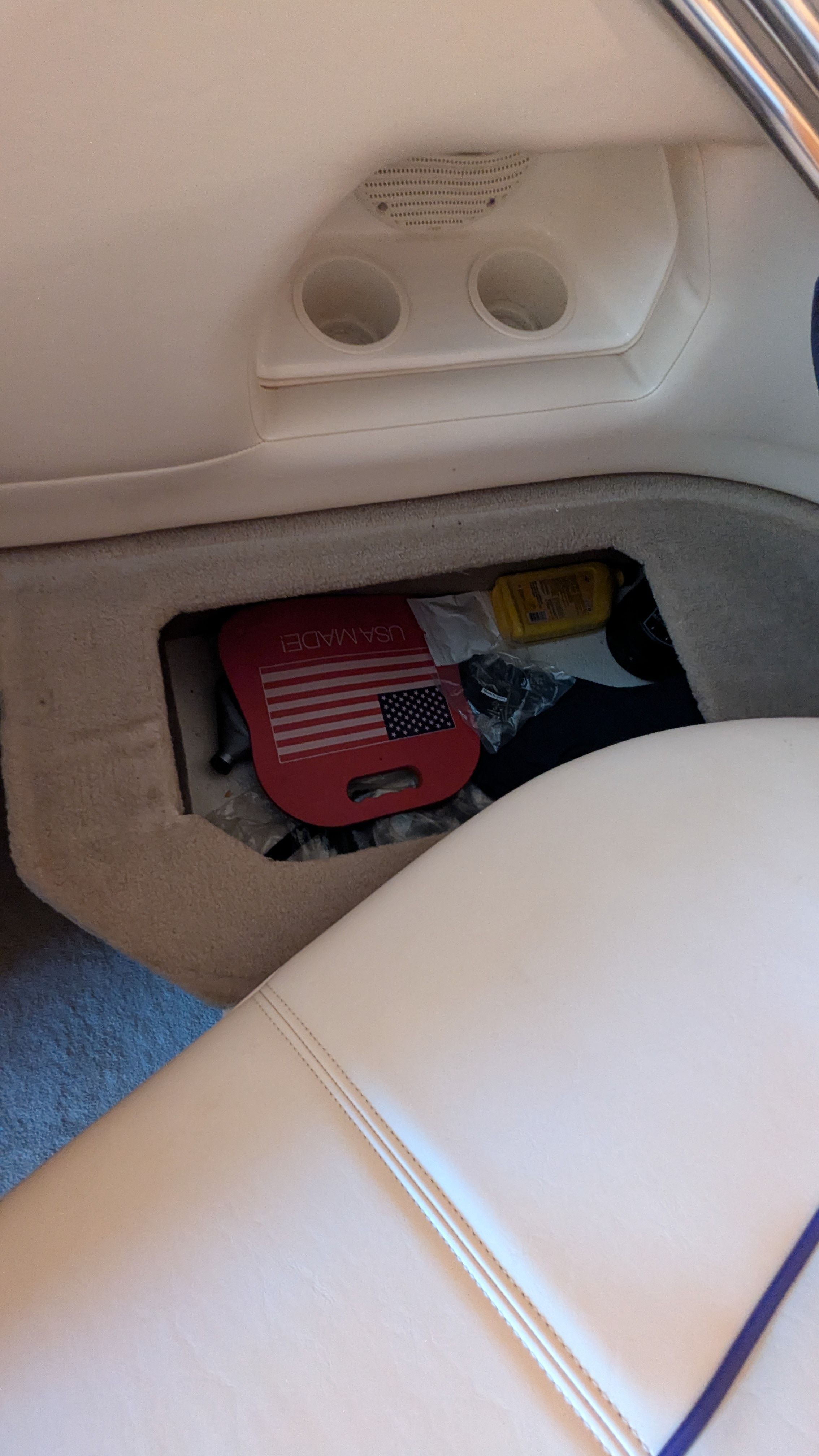 Interior of a boat with storage compartment and accessories.