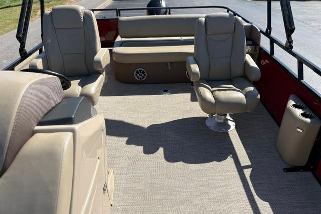 2025 Regency 250 DL3 boat interior with beige seating and carpeted flooring.