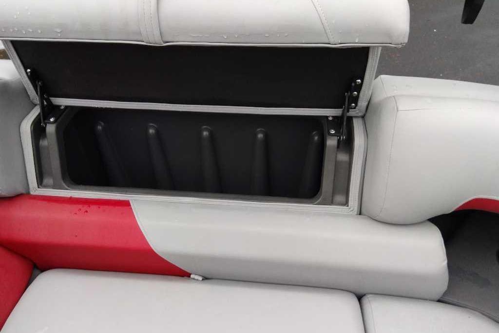 Open storage compartment on 2026 Sun Tracker Party Barge 22 XP3 boat seat.