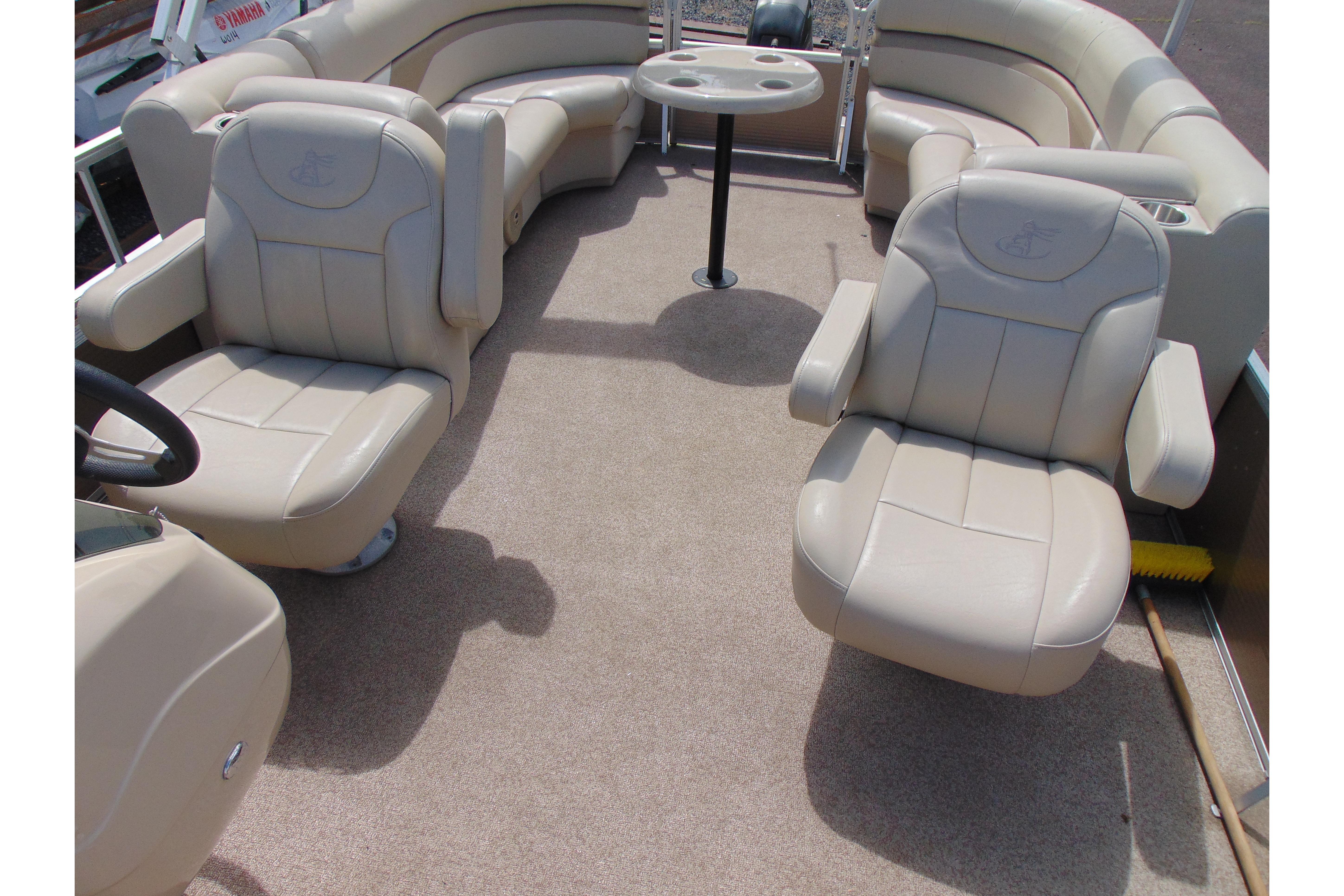 Interior of 2016 Misty Harbor 245 Adventure CU pontoon boat with beige seating.