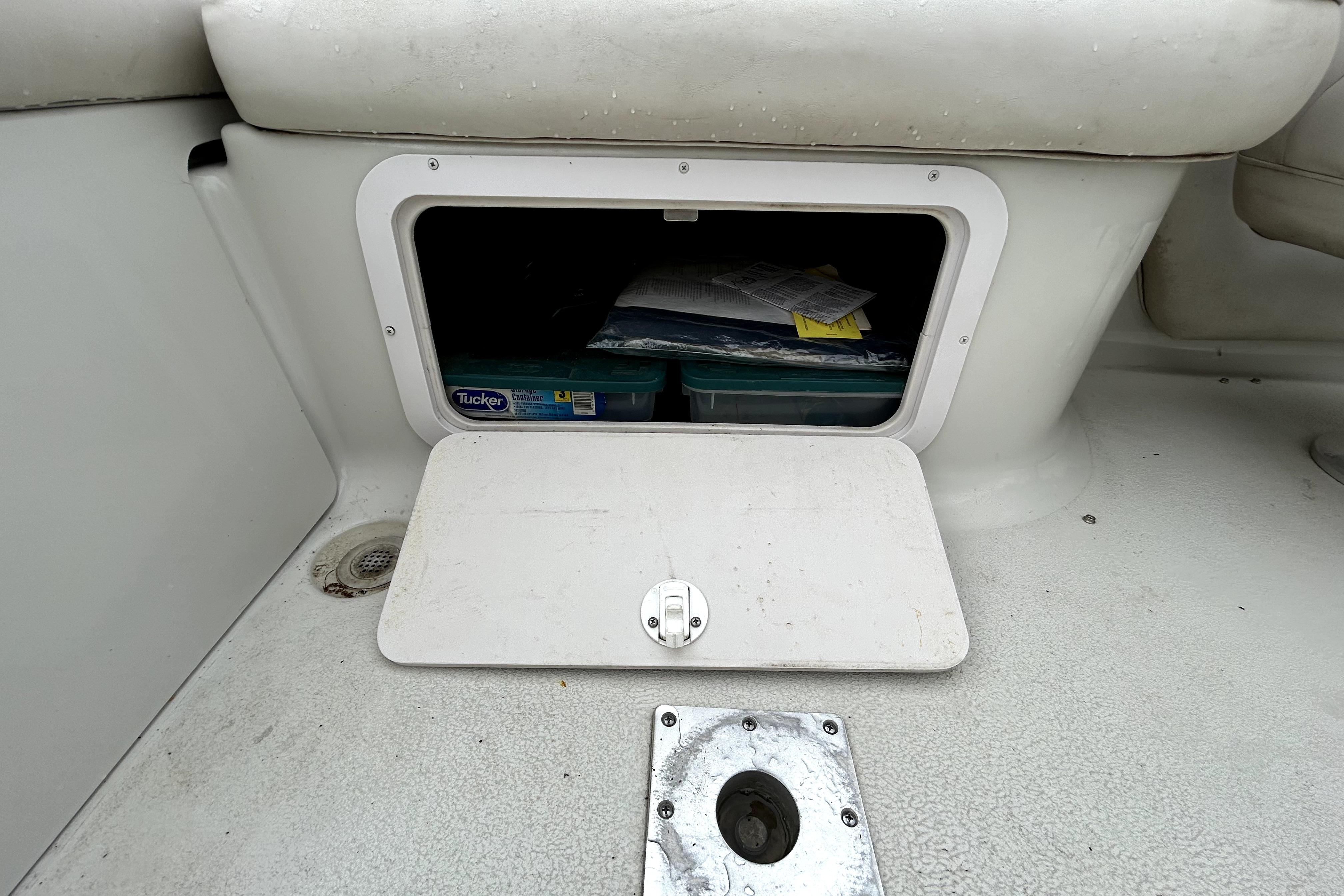 Storage compartment on a 2001 Crownline 239 DB boat, open with visible contents.