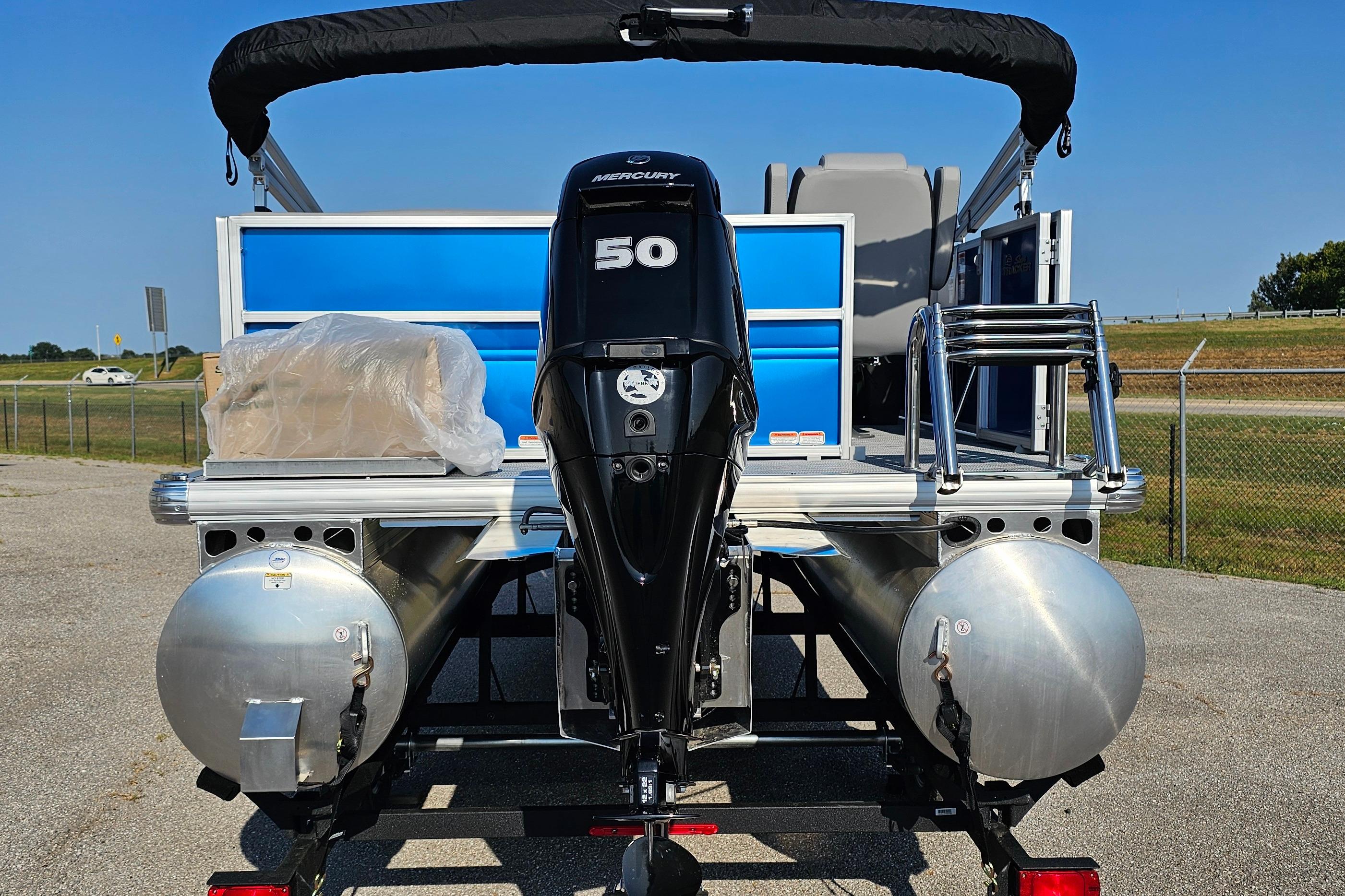 2026 Sun Tracker Party Barge 16 DLX with Mercury 50 engine, parked outdoors.
