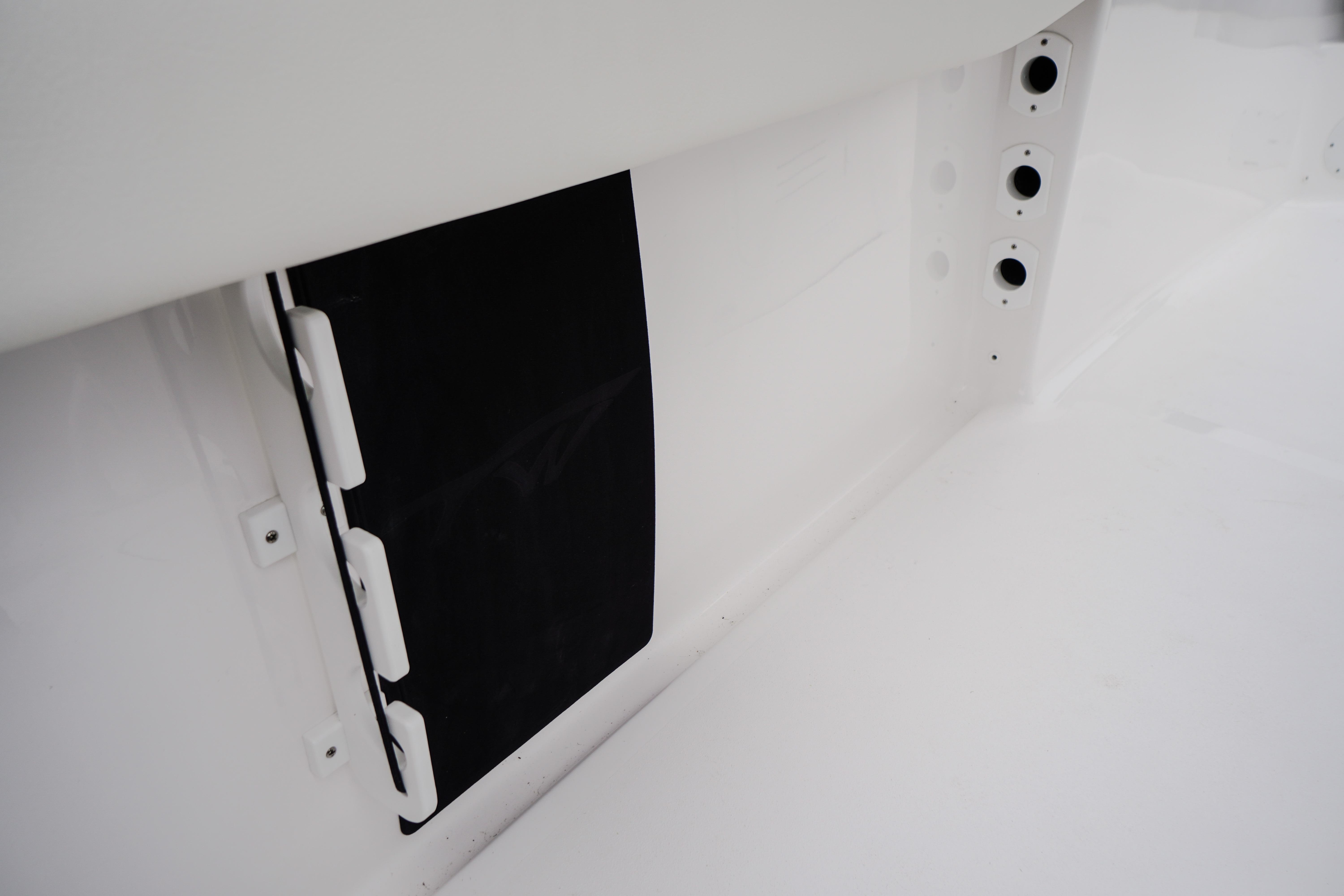 Interior detail of 2026 Tidewater 232 SS boat, featuring sleek white design elements.