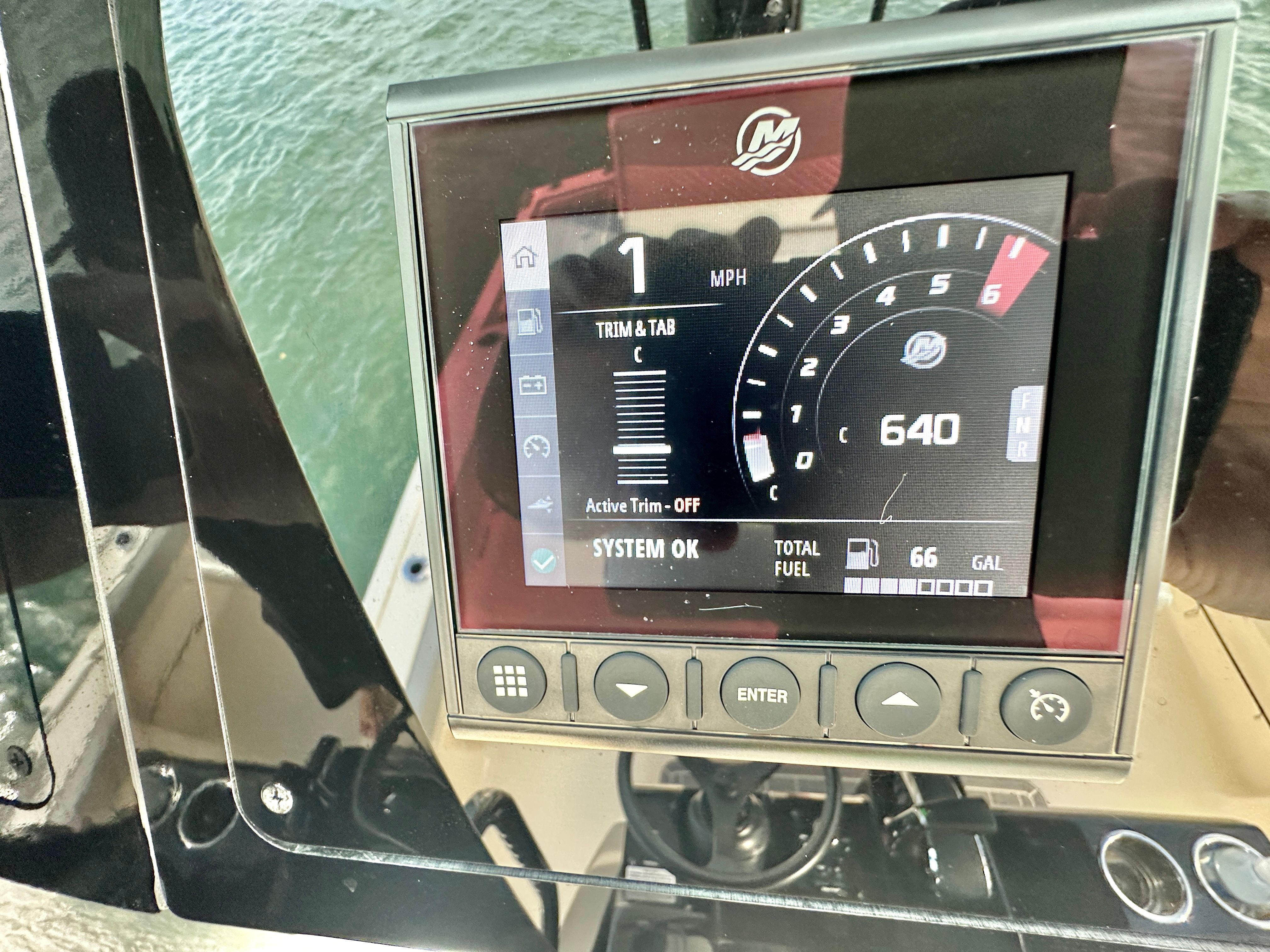 The image shows a boat instrument display with speed and fuel indicators.