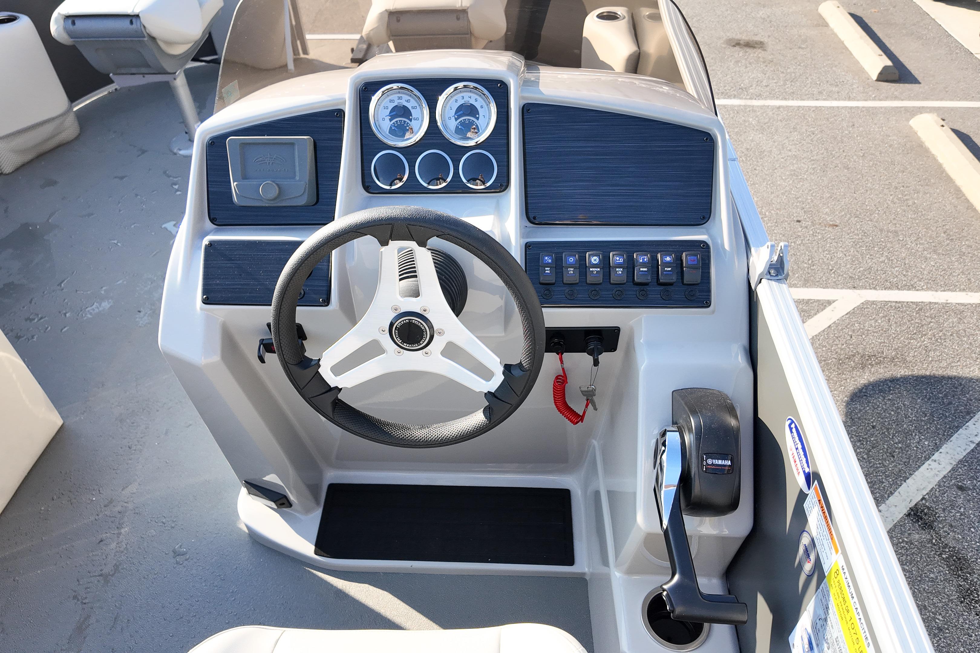 2026 Sylvan Mirage 818 Fish boat dashboard with steering wheel and control panel.