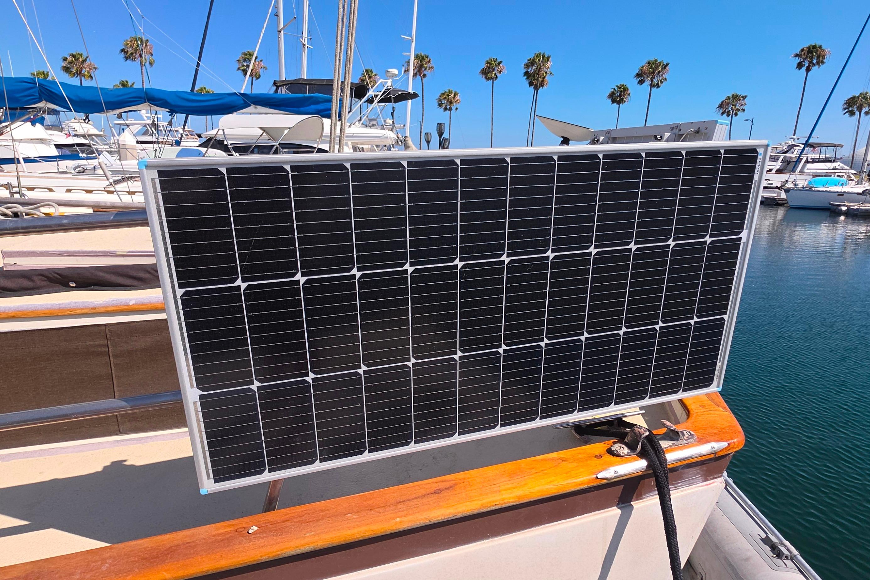 Solar panel on 1978 Islander Freeport 41 sailboat in marina with palm trees.