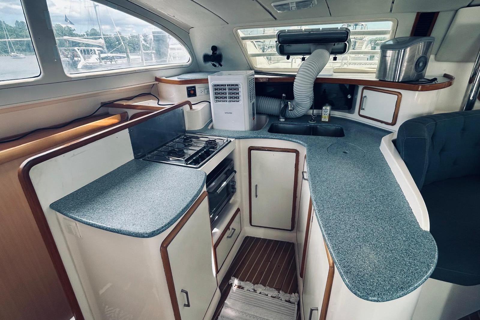 2001 Robertson & Caine Leopard yacht kitchen with stove, sink, and ample counter space.
