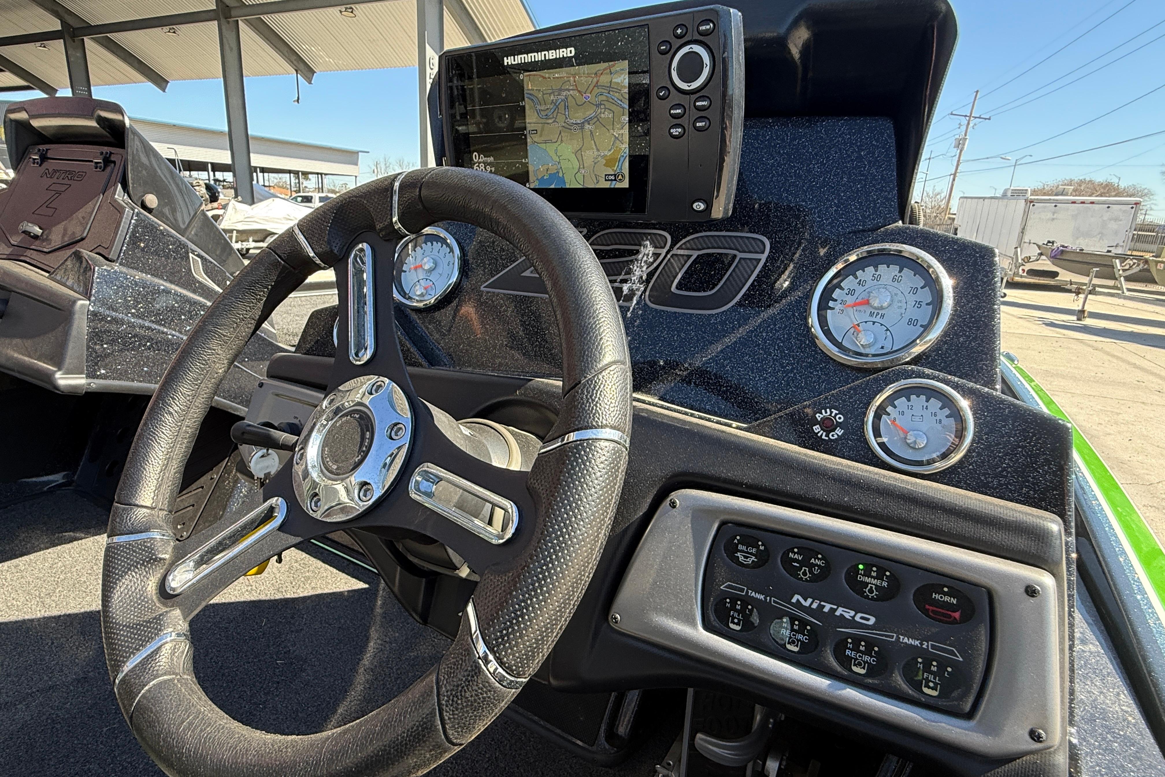 Steering wheel and dashboard of a 2020 Nitro Z20 boat with navigation display.