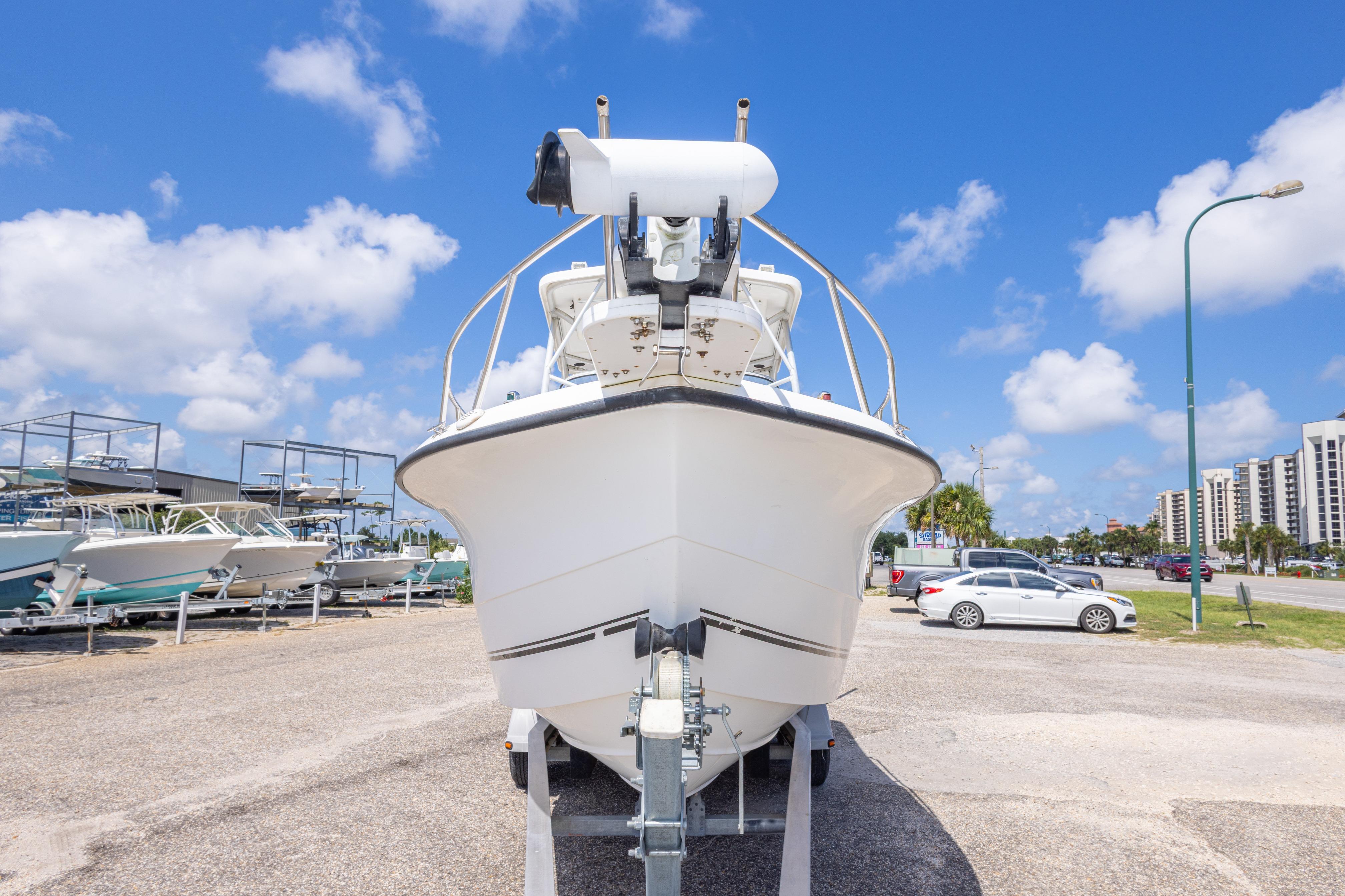 2007 Sea Boss 235 Walkaround boat on trailer under clear blue sky.
