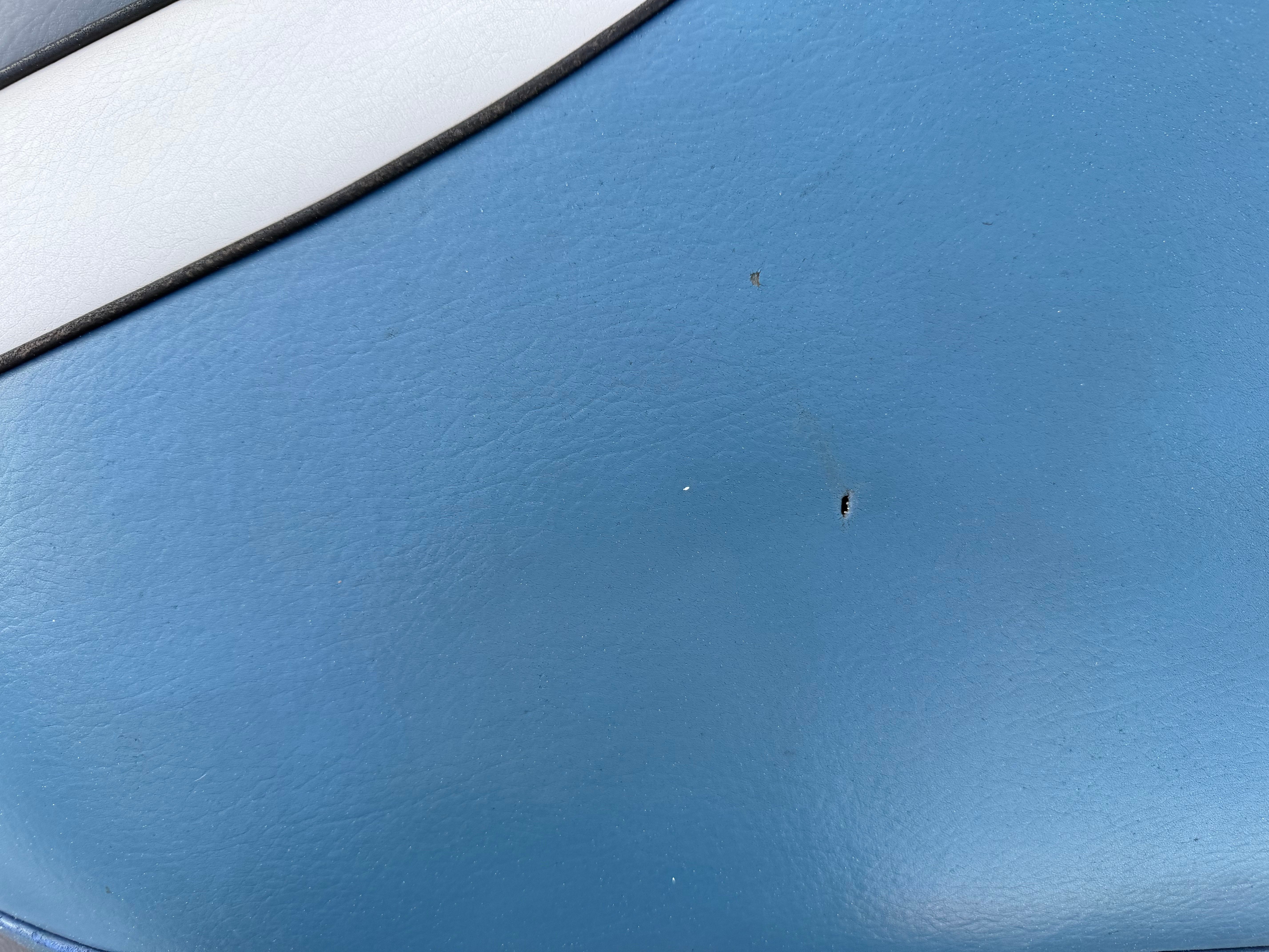 Close-up of blue 2004 MB Sports 220 with scratches.