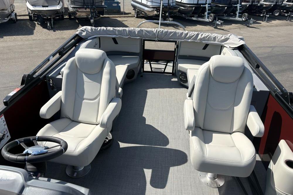 2026 SunChaser Lucerne 22 LR DH boat interior with plush seating and steering wheel.