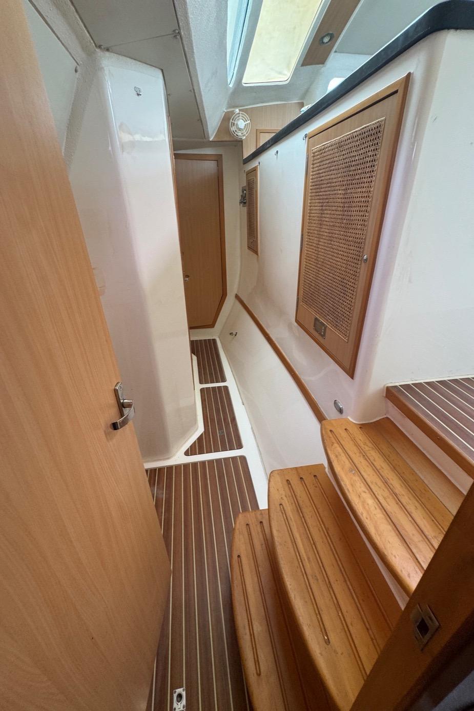 Interior of 2010 Admiral 38 Executive yacht with wooden flooring and steps.