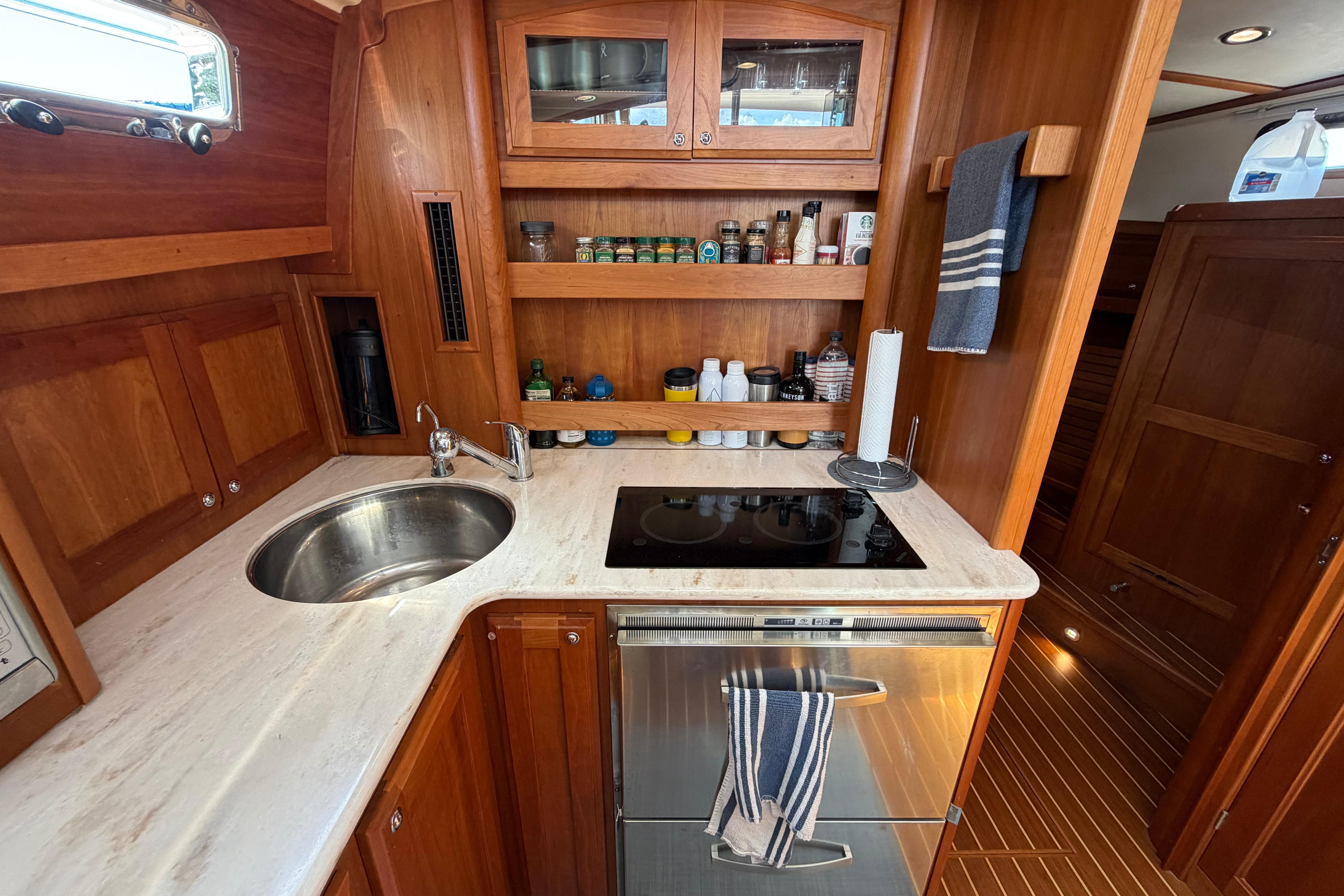 2015 Sabre 38 Salon Express galley with wooden cabinetry and modern appliances.
