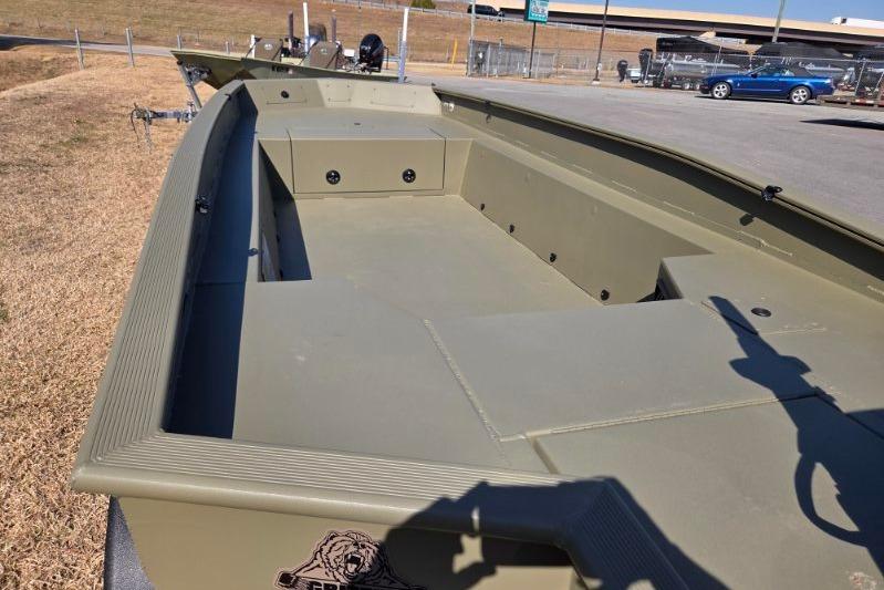 2026 Tracker Grizzly 1650 T Prairie Wings Edition boat, olive green, parked outdoors.