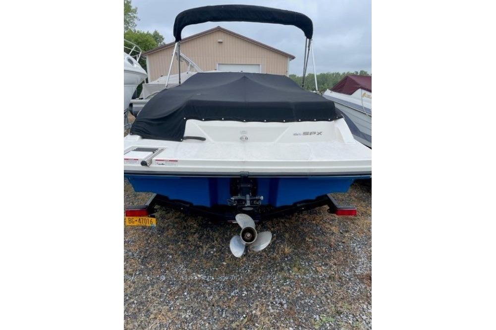 Rear view of a 2015 Sea Ray 210 SLX boat with cover and trailer.