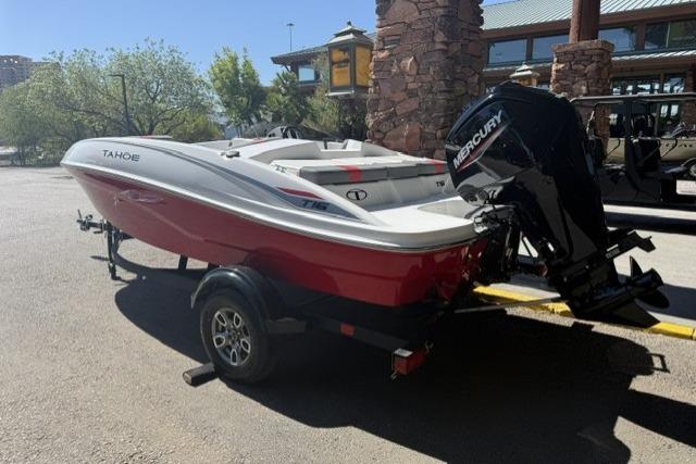 2026 Tahoe T16 boat with Mercury engine on trailer, parked outdoors.