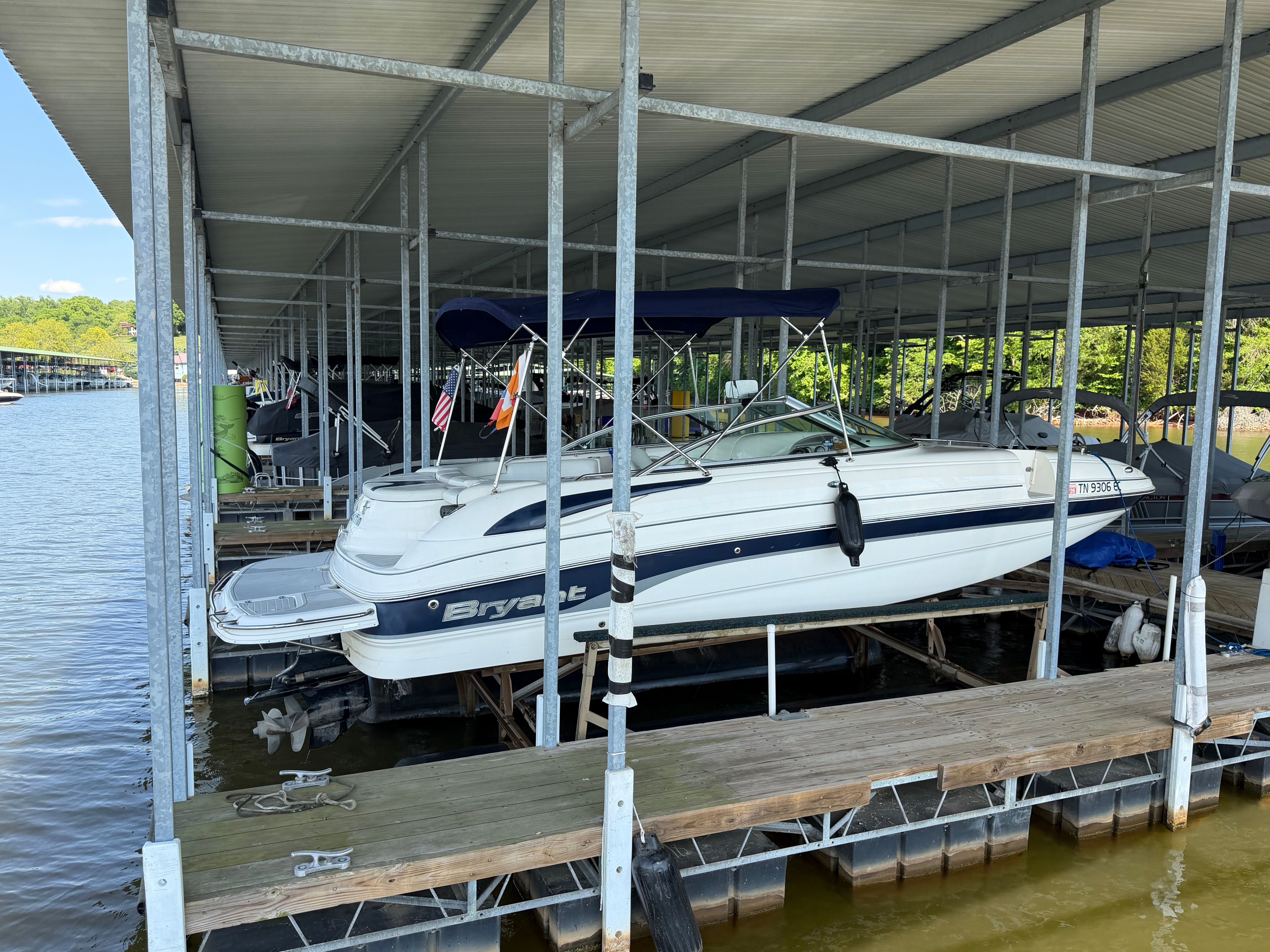 2010 Bryant 255 boat docked in covered marina.