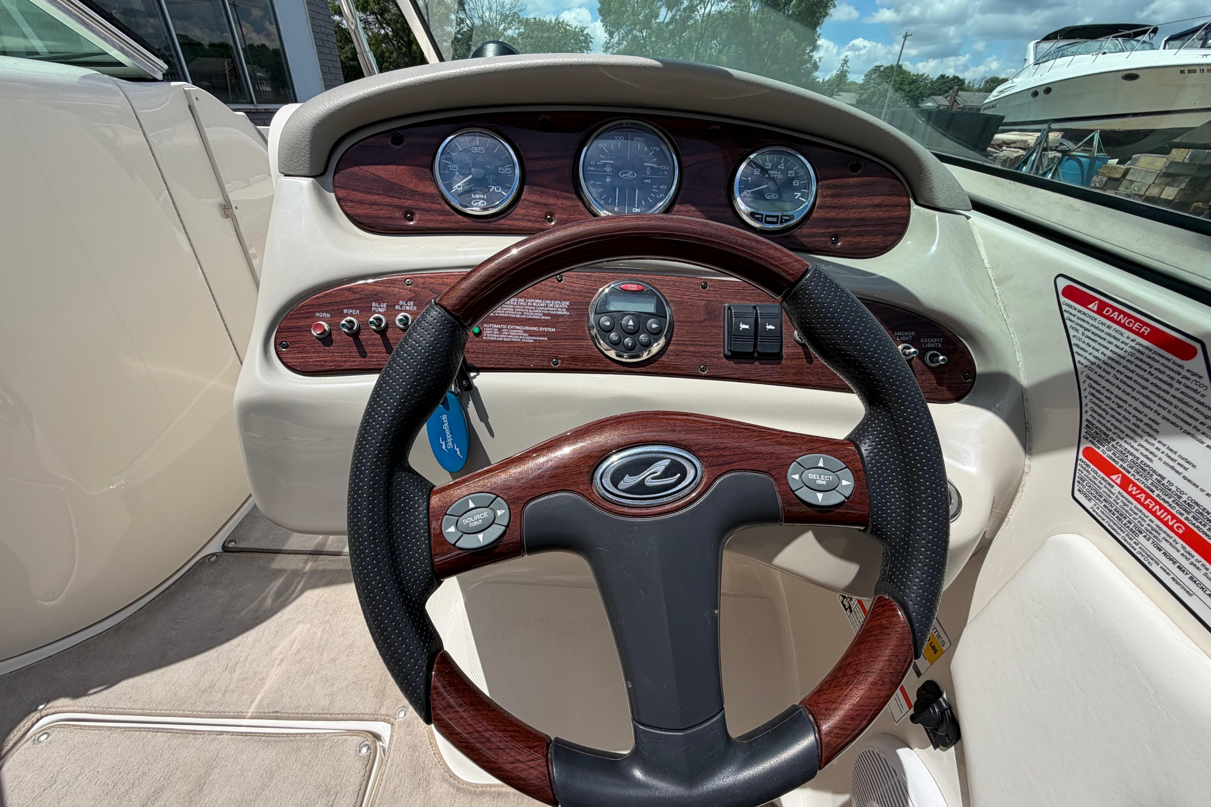 Steering wheel and dashboard of a 2004 Sea Ray 240 Sundeck boat.
