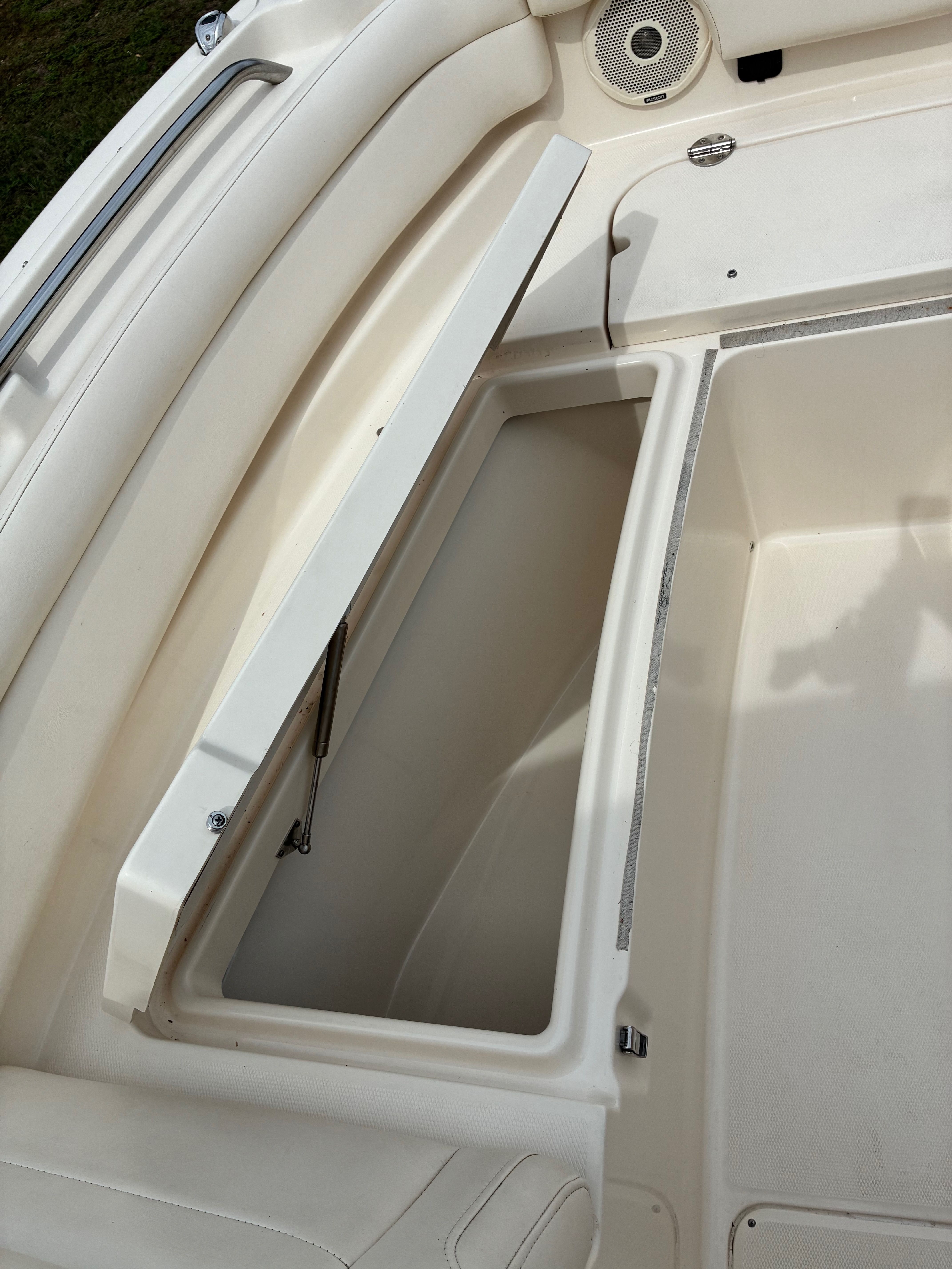 2018 Grady-White Freedom235 boat with open storage compartment.